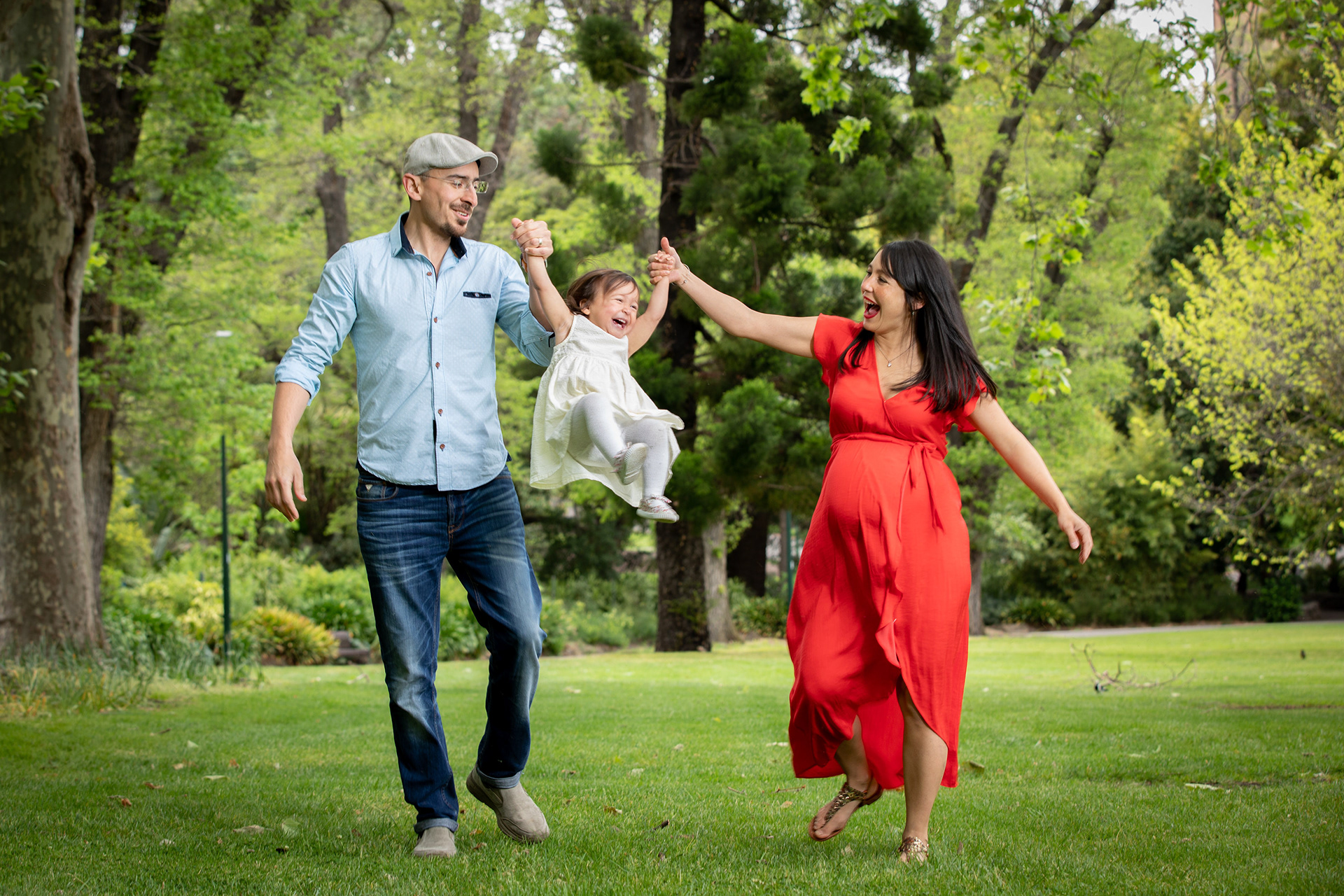 Family walking together across a grassy park