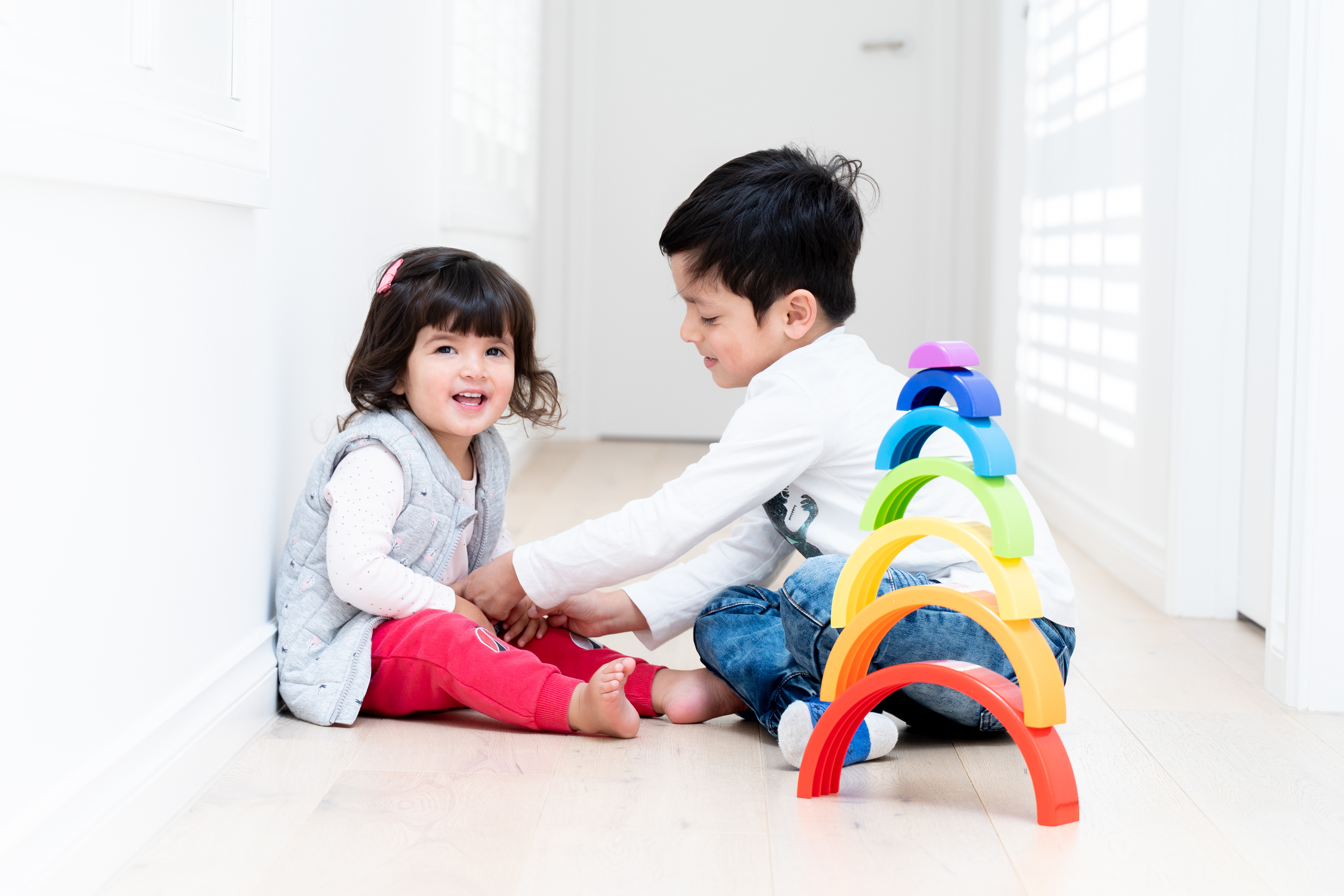 Parent and child playing with toys on a sofa