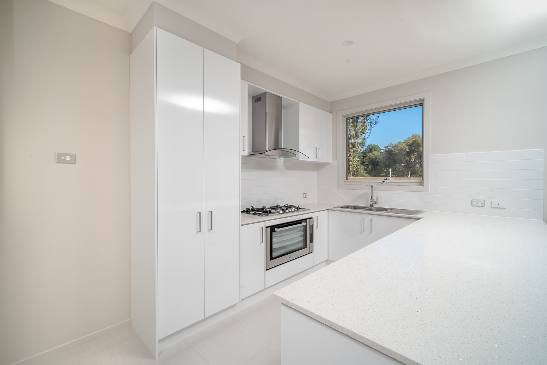 White kitchen with a gas cooktop and garden window