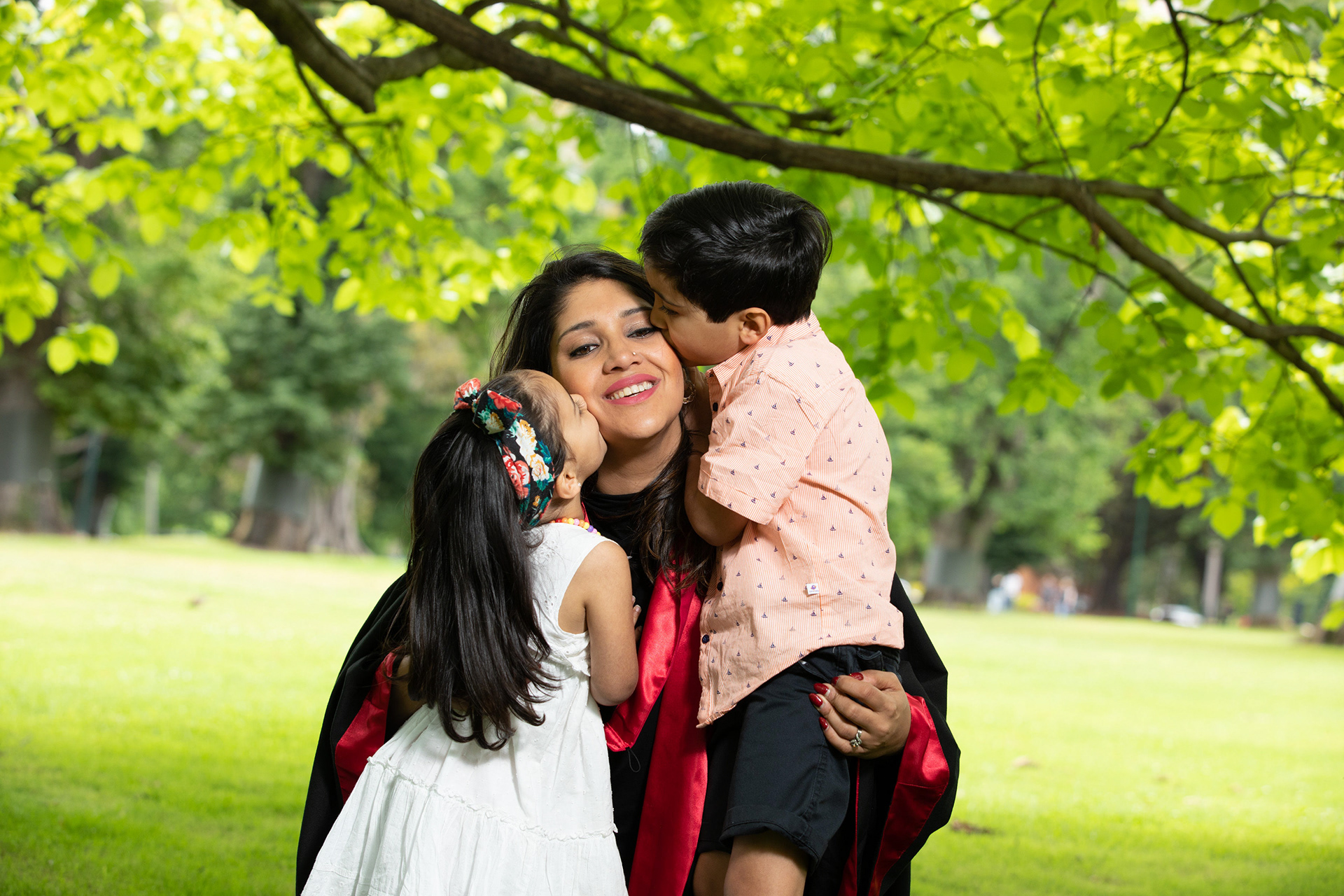 Family gathered beneath a tree during an outdoor session
