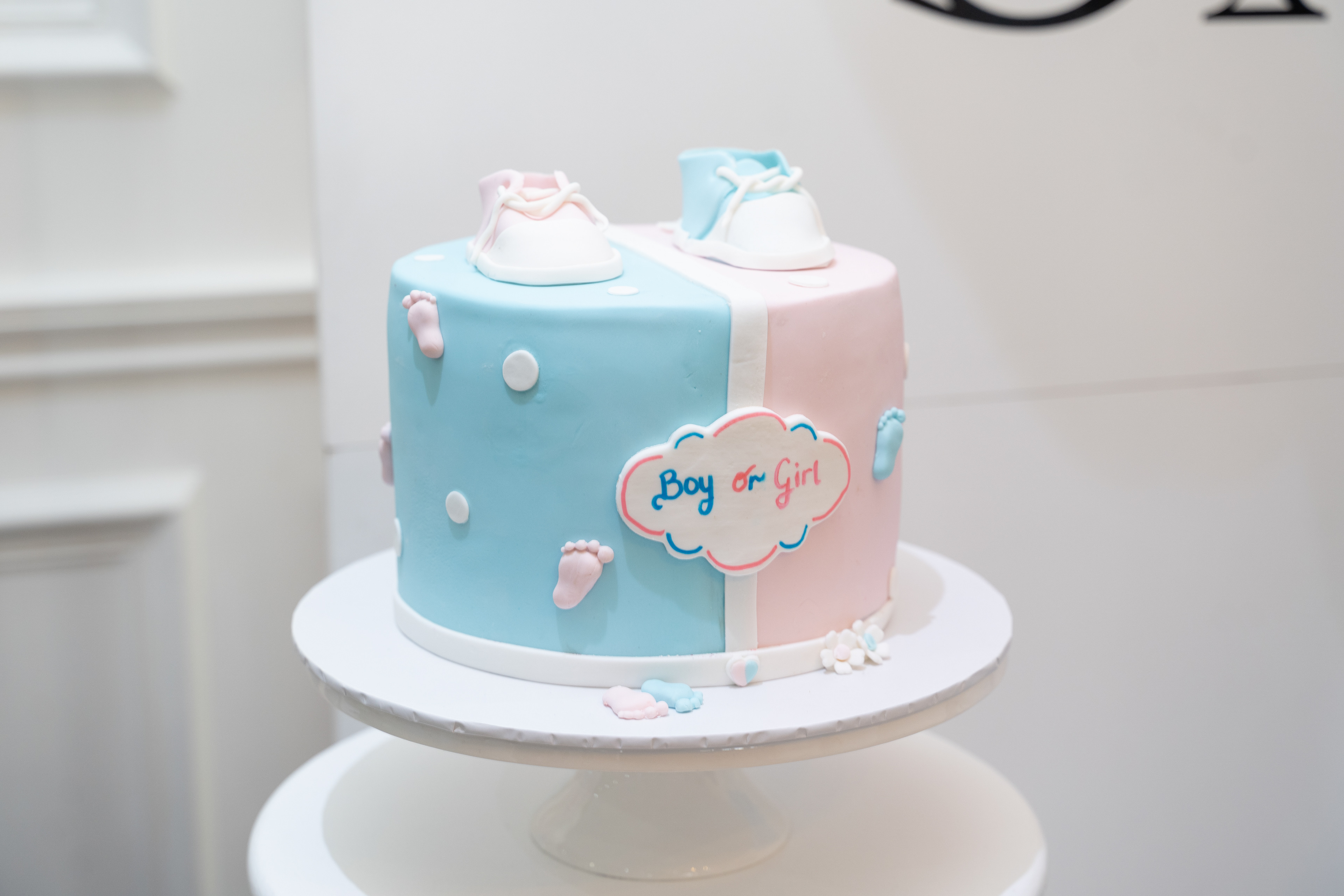 Blue celebration cake displayed on a white cake stand