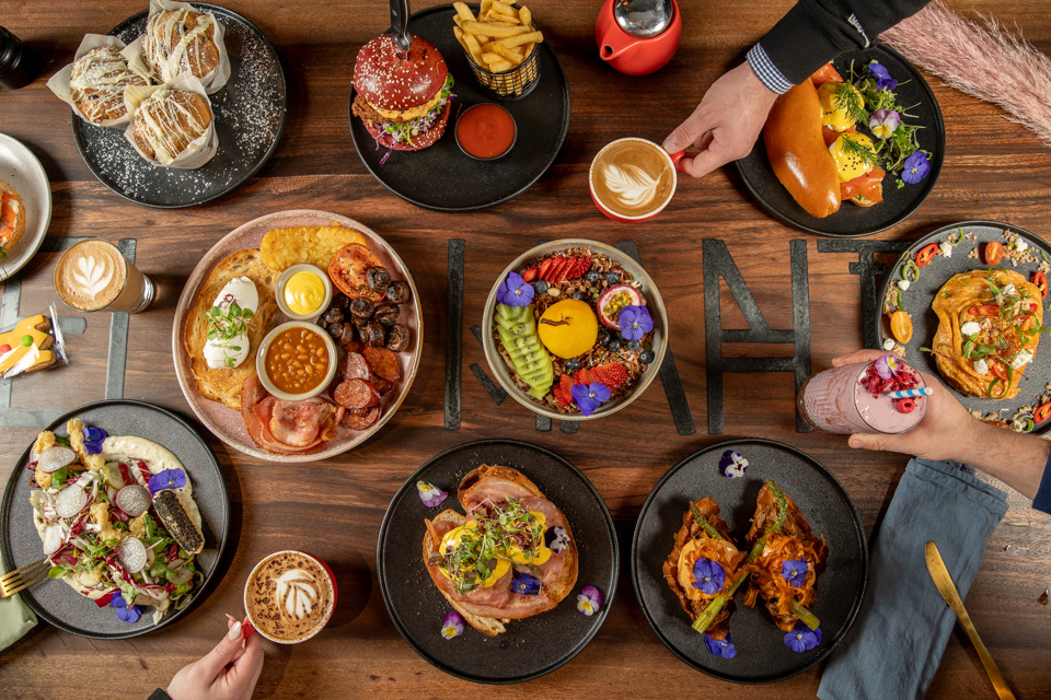 Overhead view of a shared feast with bowls and side dishes