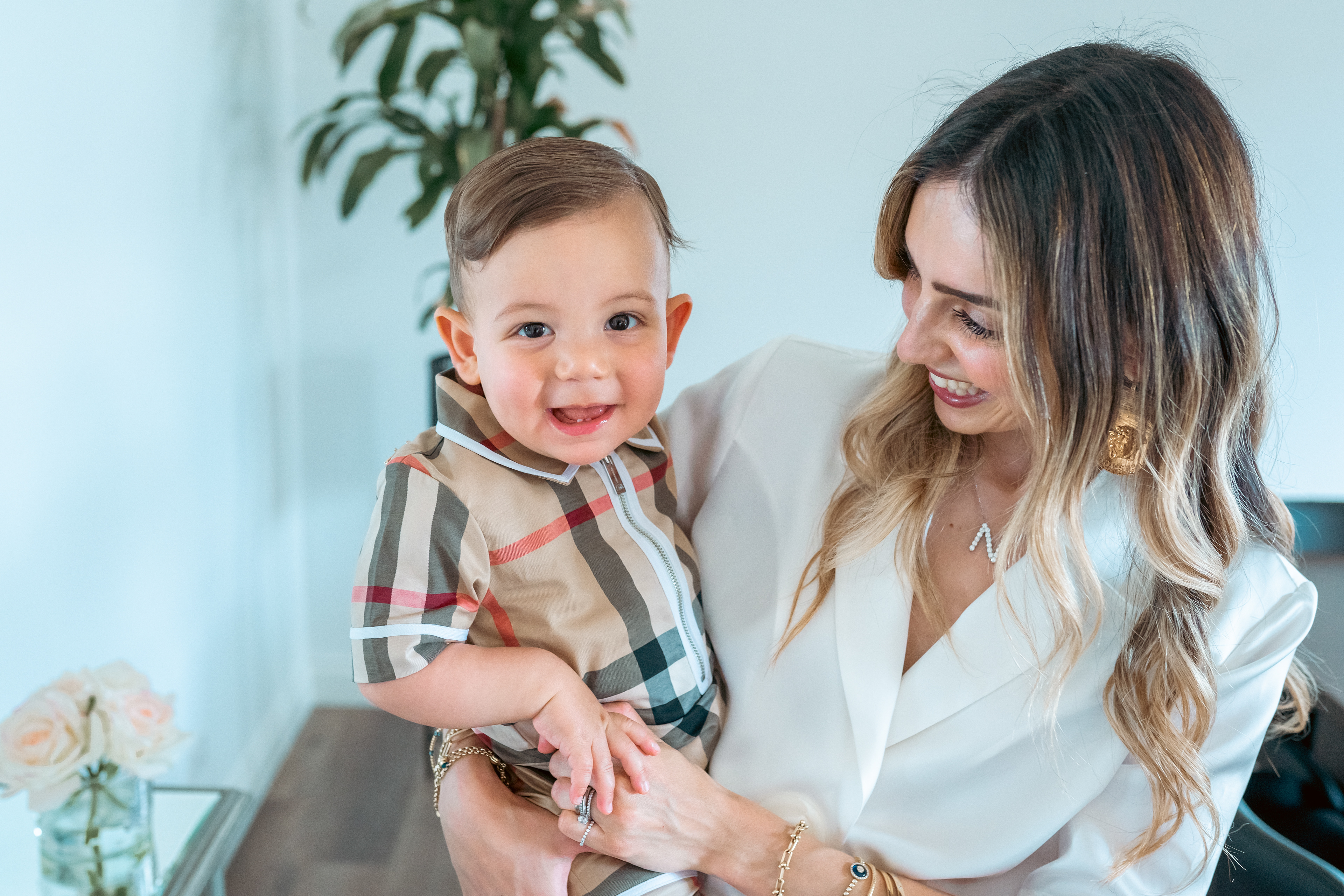 Parent holding a smiling toddler at a celebration