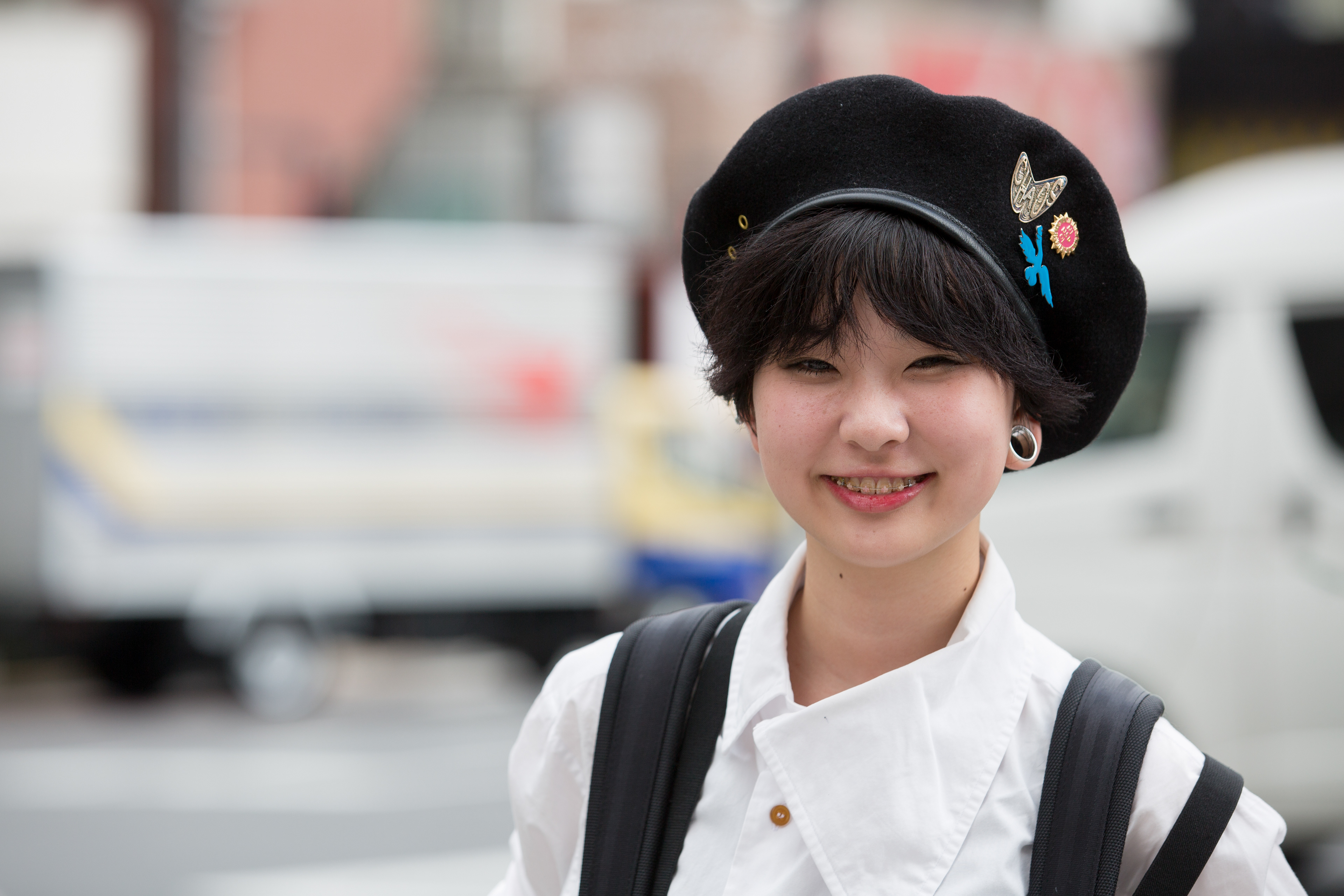 Side-profile outdoor portrait with a softly blurred background