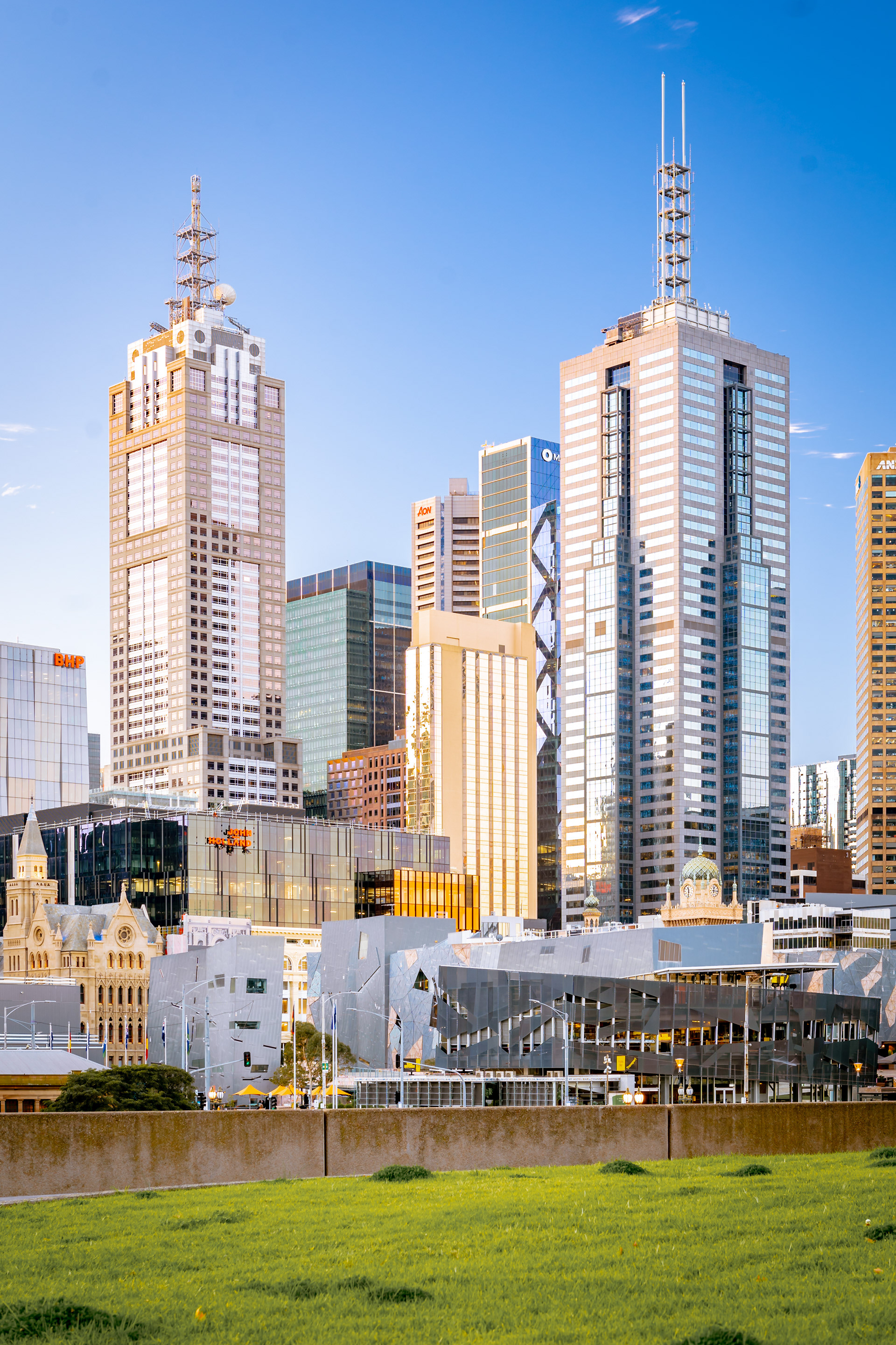 Vertical view of Melbourne skyscrapers beside the river
