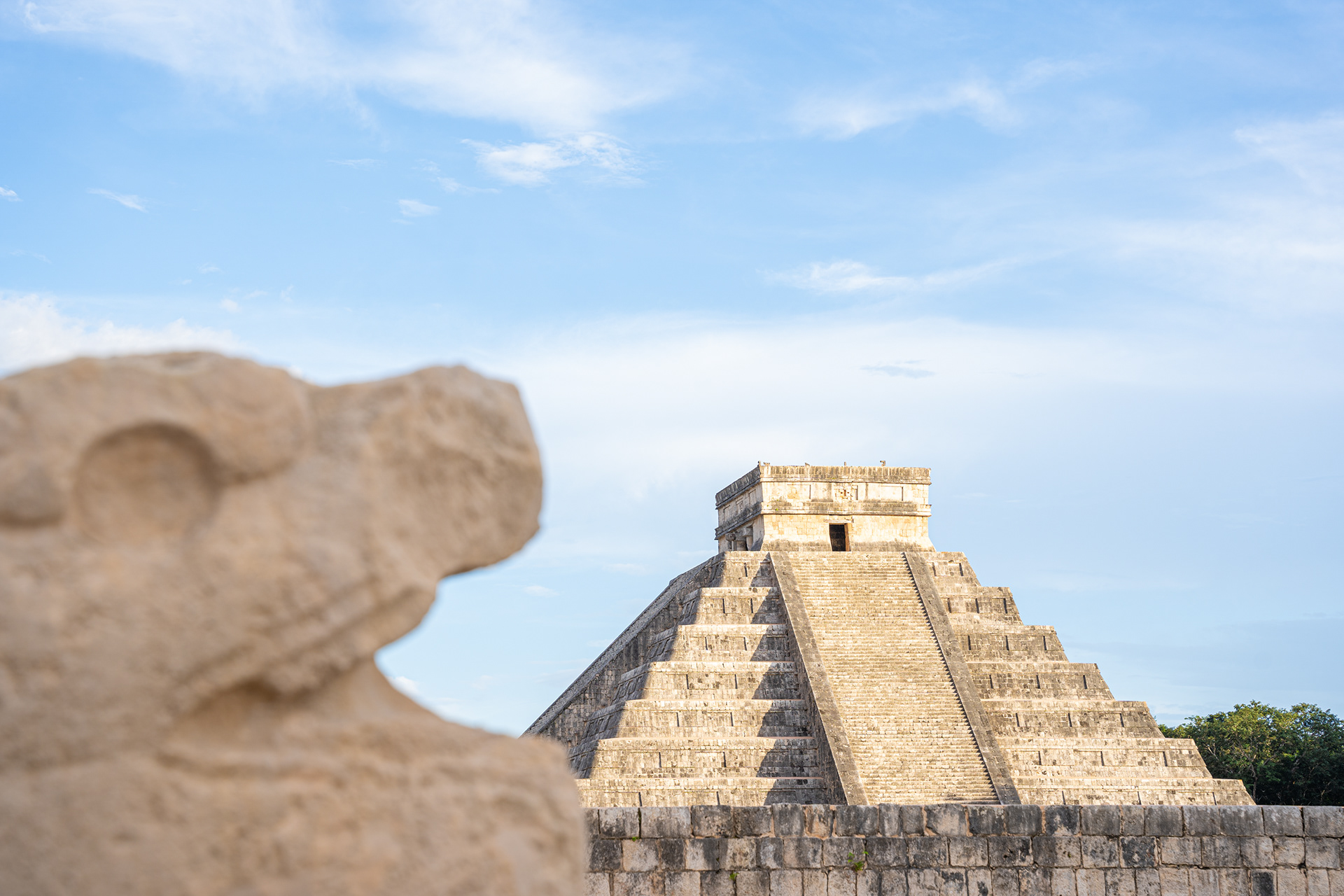 Stone pyramid and carved stone detail at Chichen Itza
