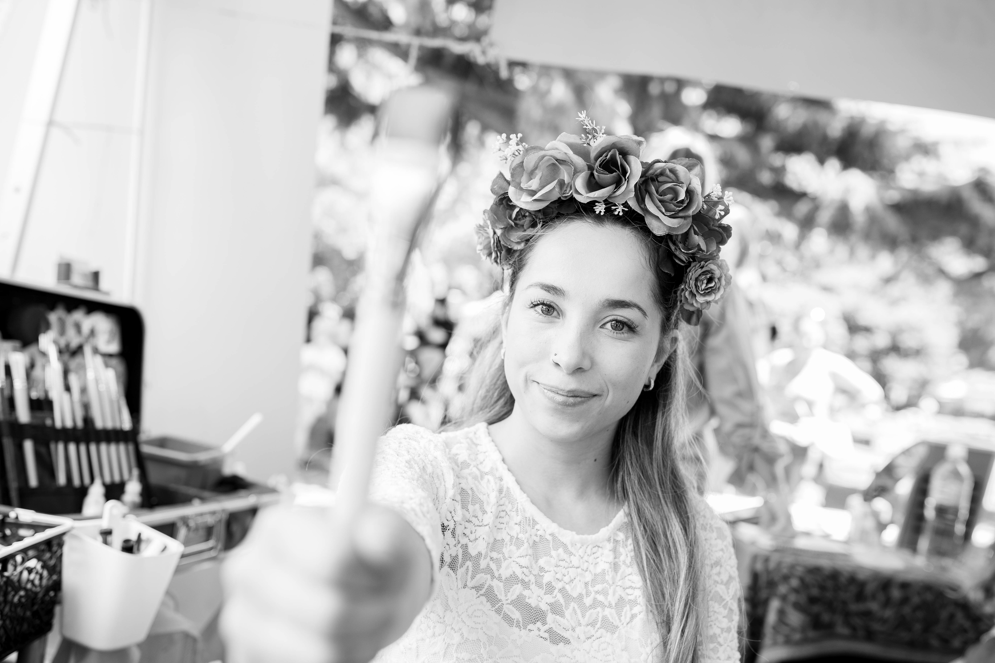 Black-and-white portrait of a guest wearing a flower crown