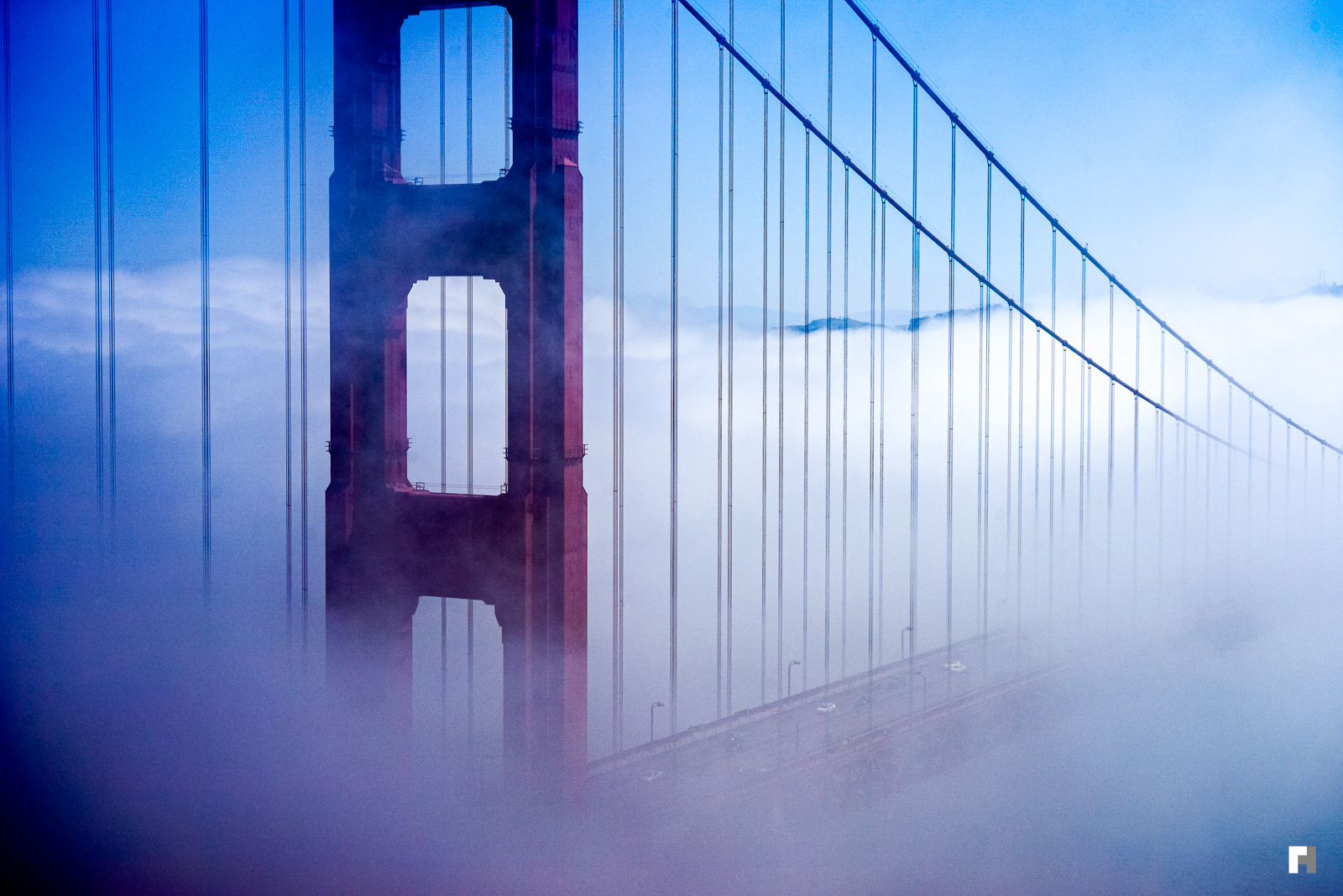 Golden Gate leading into cloudy San Francisco.