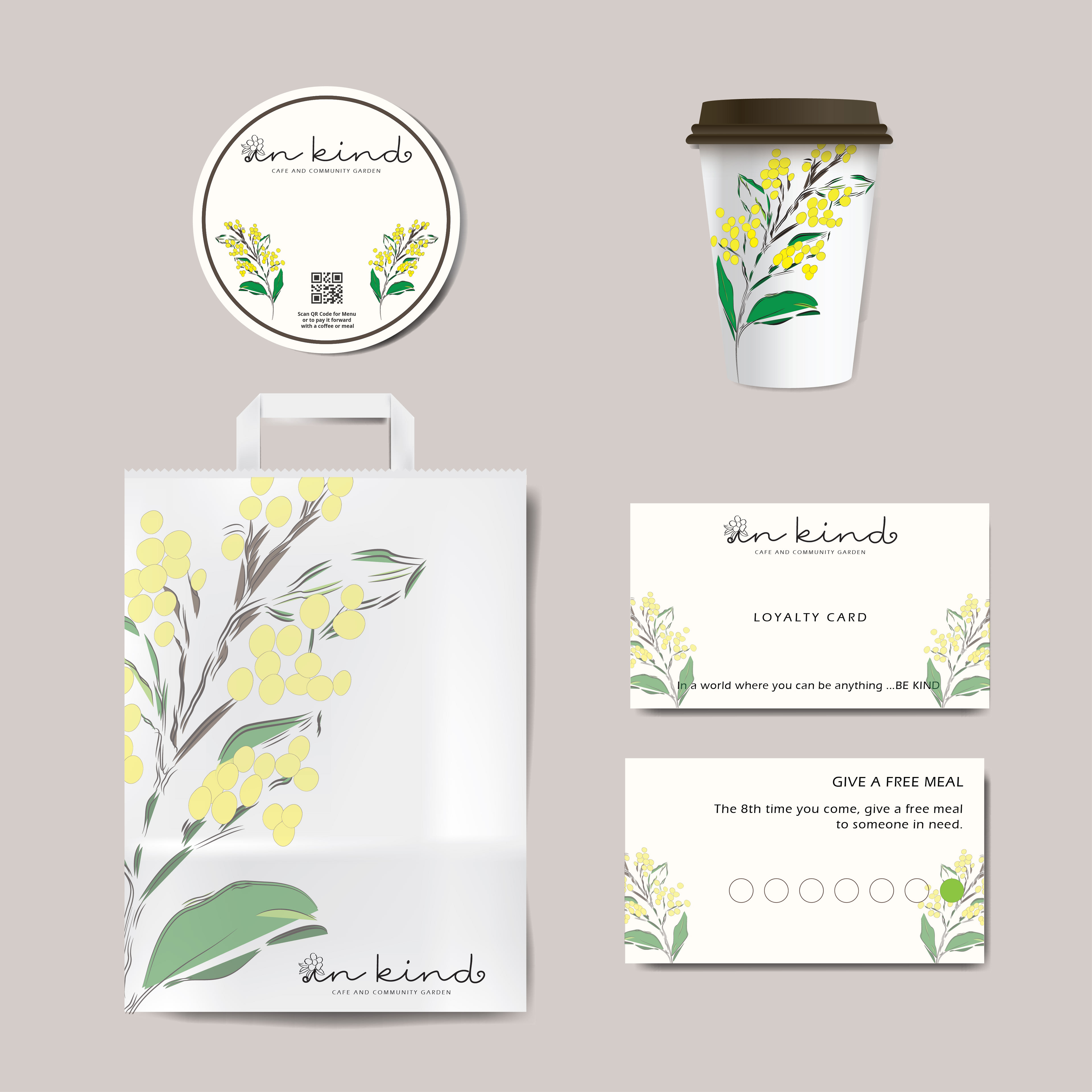 A branding concept mockup for 'In Kind' cafe and community garden featuring a coaster, takeaway coffee cup, white paper bag, and loyalty card. Each item displays the custom script logo with a flower replacing the dot on the 'i', alongside a hand-drawn wattle motif. The front of the loyalty card reads 'In a world where you can be anything ... Be Kind,' and the back states 'The 8th time you come, give a free meal to someone in need.
