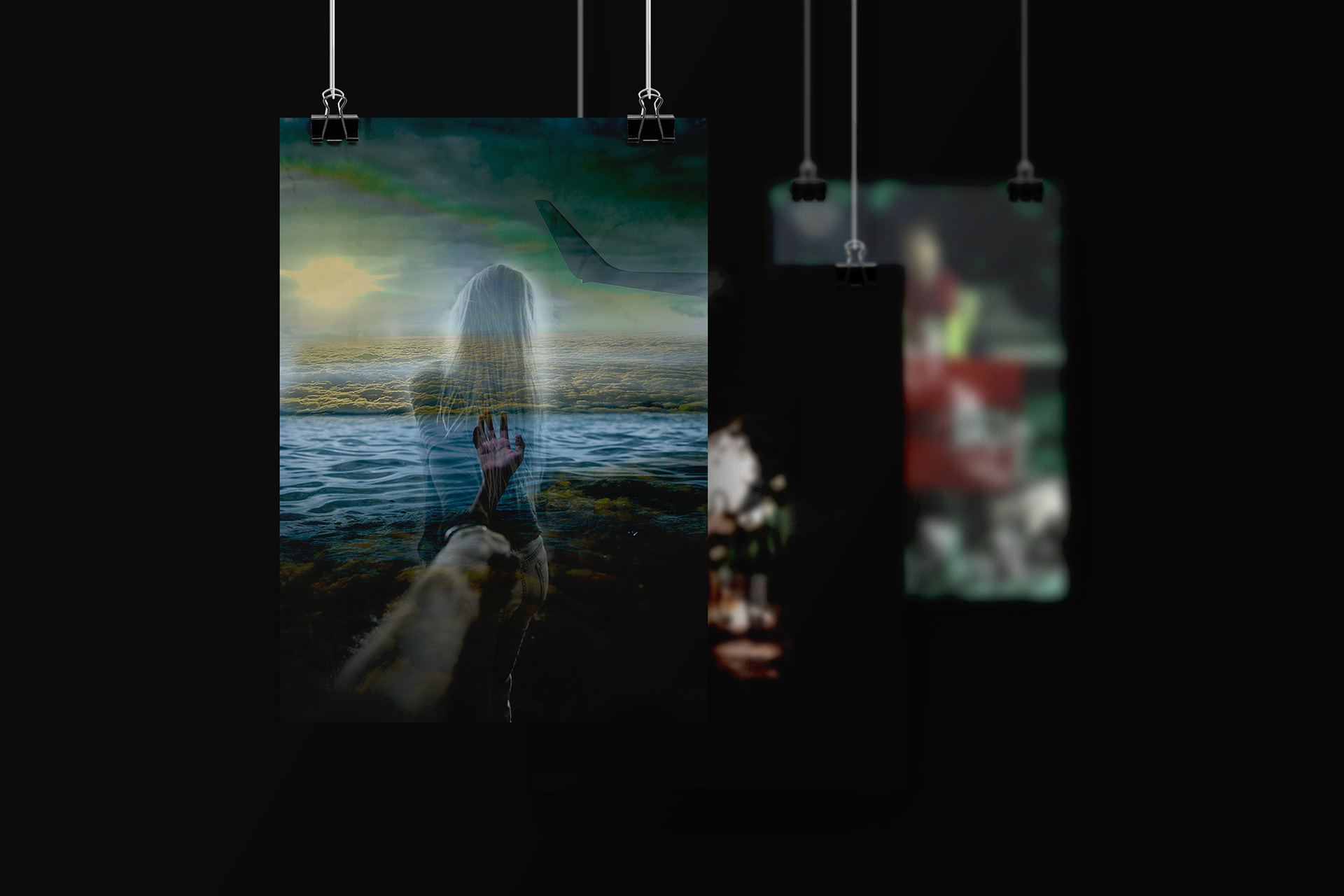 Three hanging poster mockups with the front poster as the main focal point. A skyscape of white fluffy clouds blended with a dark mass of water, with a hand reaching out from the depths. An aeroplane's wing appears to the right of the image. A woman guides a man by the hand through the skyscape as the sun shines in the distance