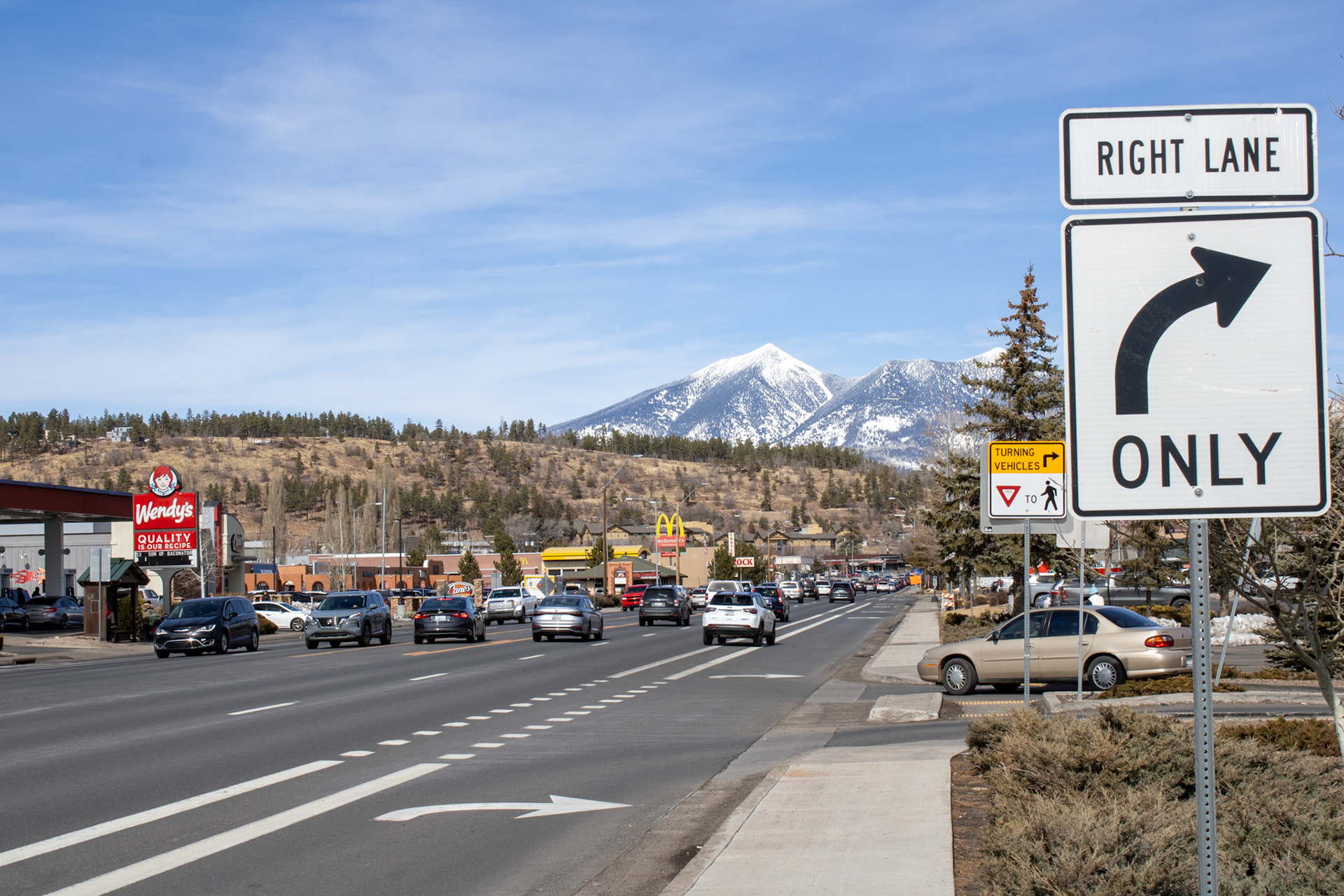 Street view showing various businesses lining the road. 
