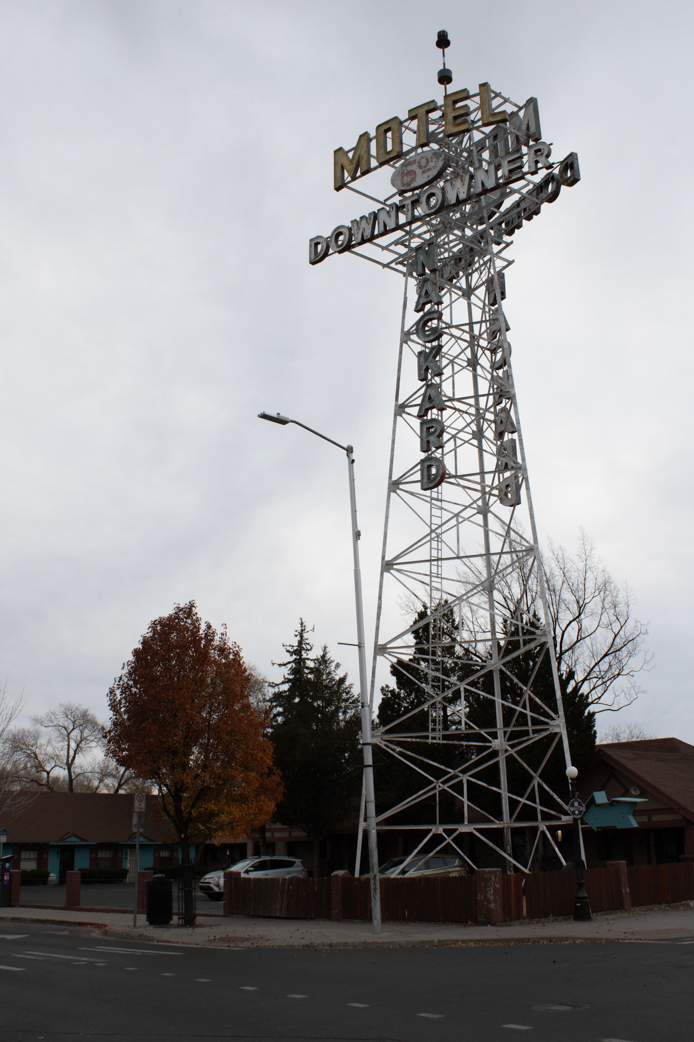 Motel sign on a street corner. 