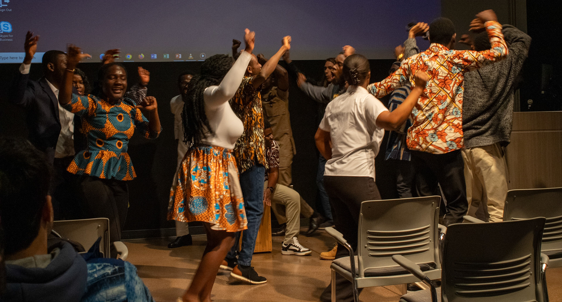 People dancing in celebration at the NAU International Pavilion. 