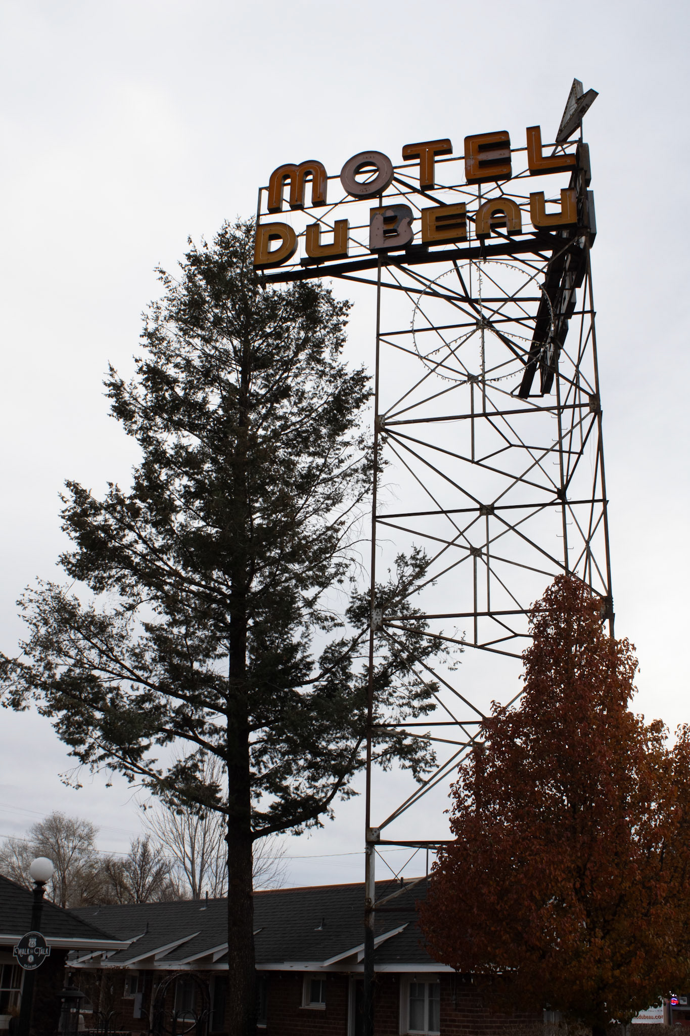 Motel DuBeau sign on a street corner. 