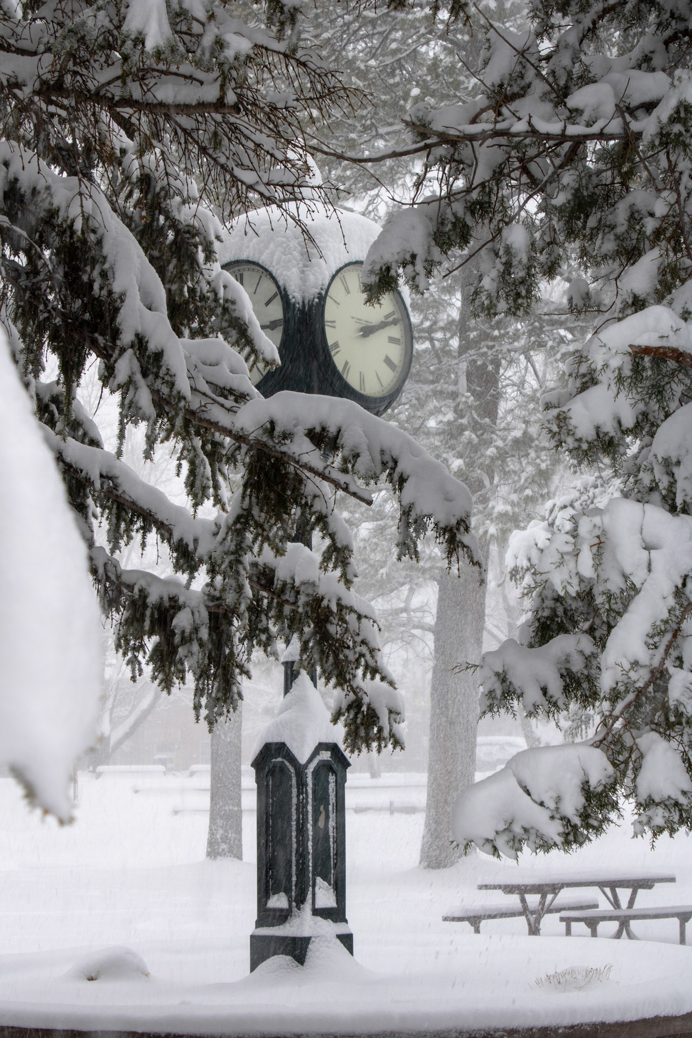 Clock at NAU North Quad surrounded by snow. 