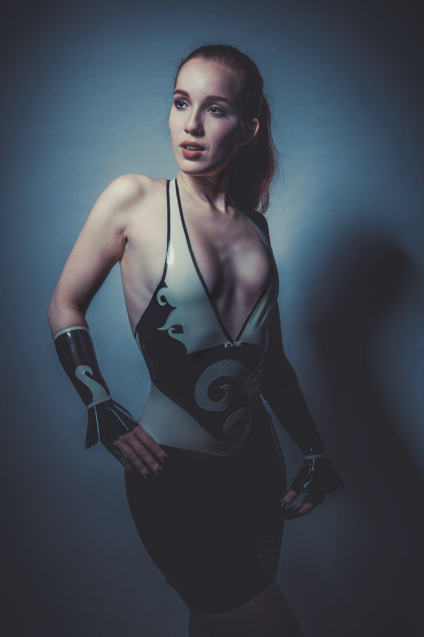 A bespoke latex suit does indeed highlight lines in the light