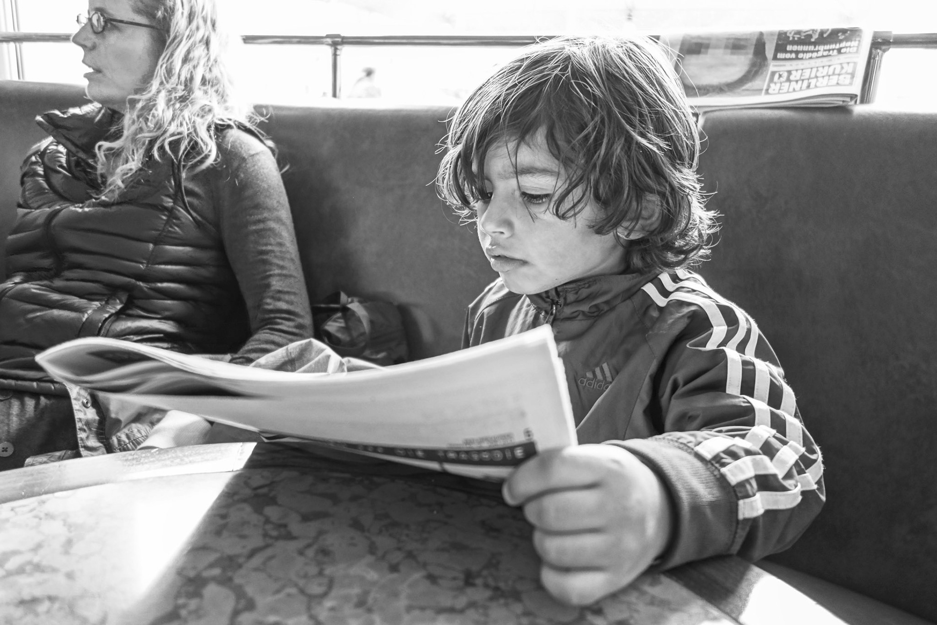 Reading the News near Friedrichstraße