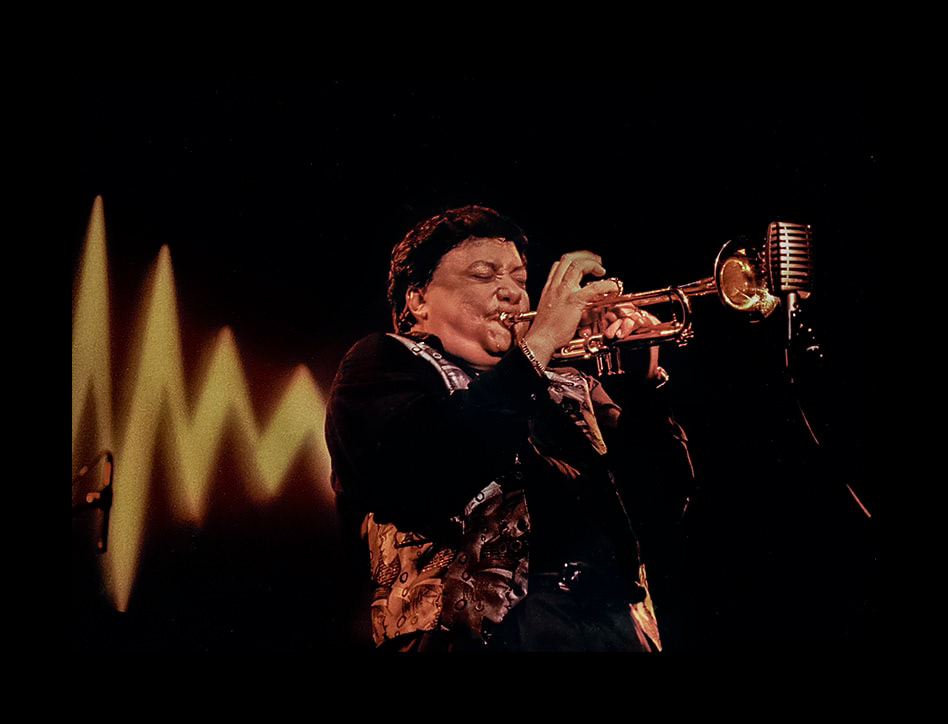 Trumpeter Arturo Sandoval appears to have lightening coming out of his back