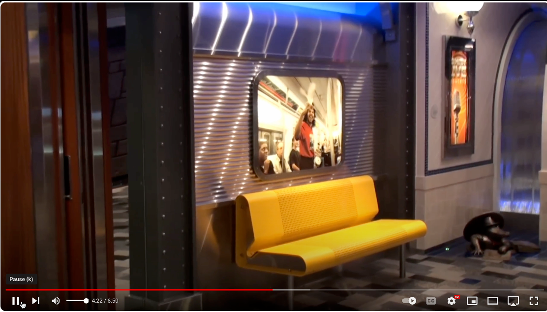 Entrance to the comedy club, featuring the alligator sculpture, a screenshot from a YouTube vide by Derek Picone