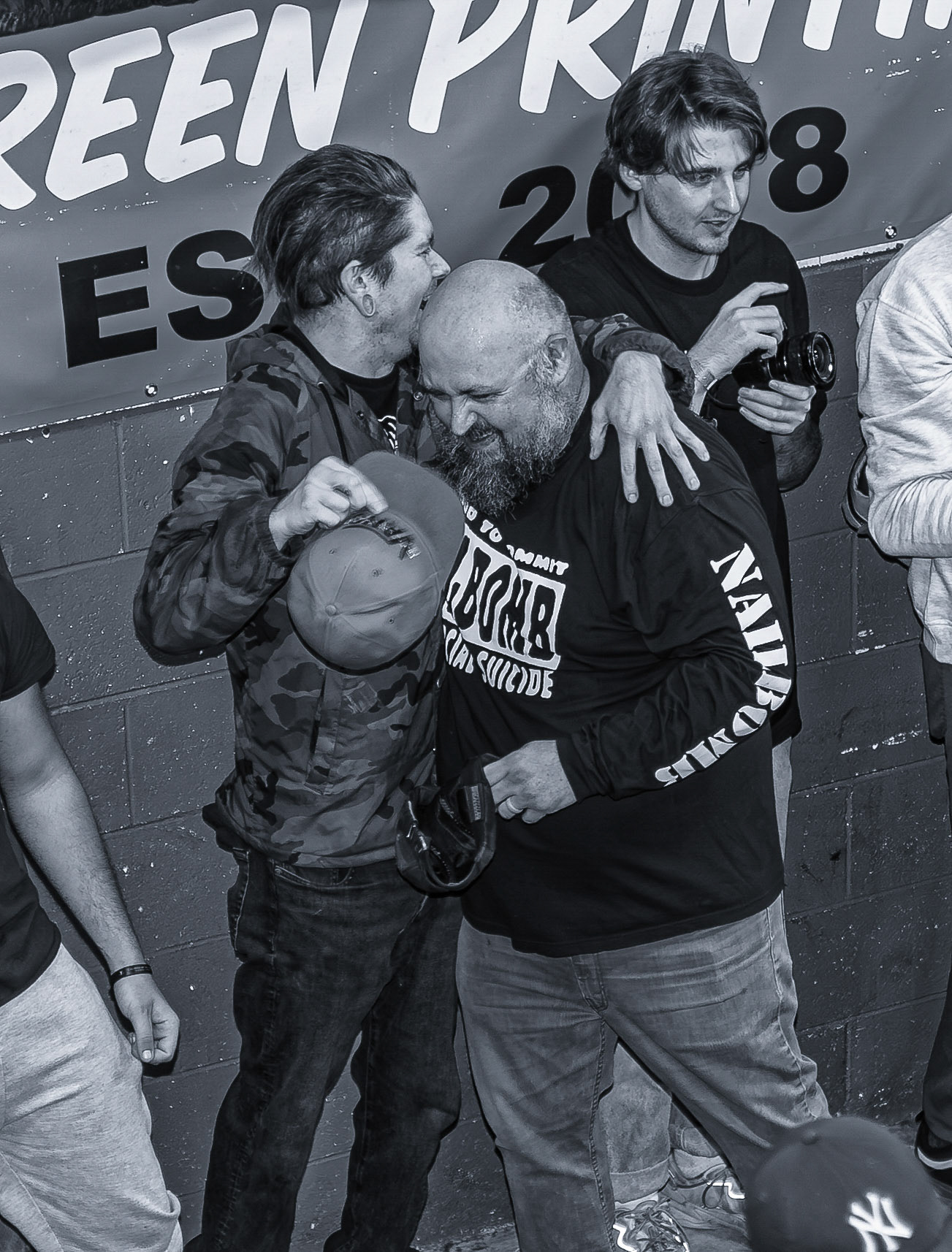 Two friends embrace after one crowdkilled the other during a song at Dbloc’s album release show on Sept. 19, 2026, at Edgemen Screen Printing in Clinton Township, Michigan. The moment reflects the deeo connection between members of Detroit’s hardcore scene despite the physical intensity of the performance.