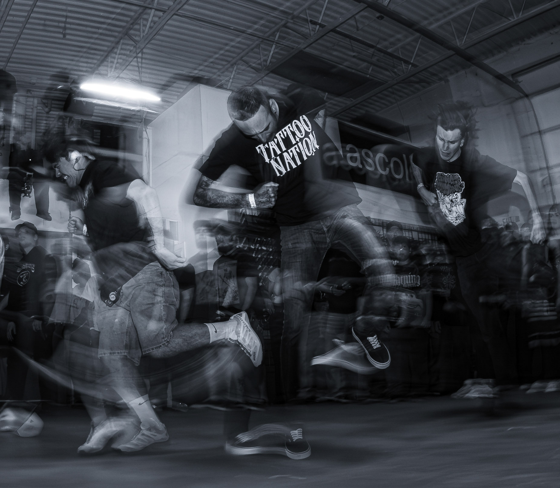 Detroit hardcore fans perfom the classic hardcore dance called the two-step during Dblocs album release show on Sept. 19, 2026, at Edgemen Screenprinting in Clinton Township, Michigan.