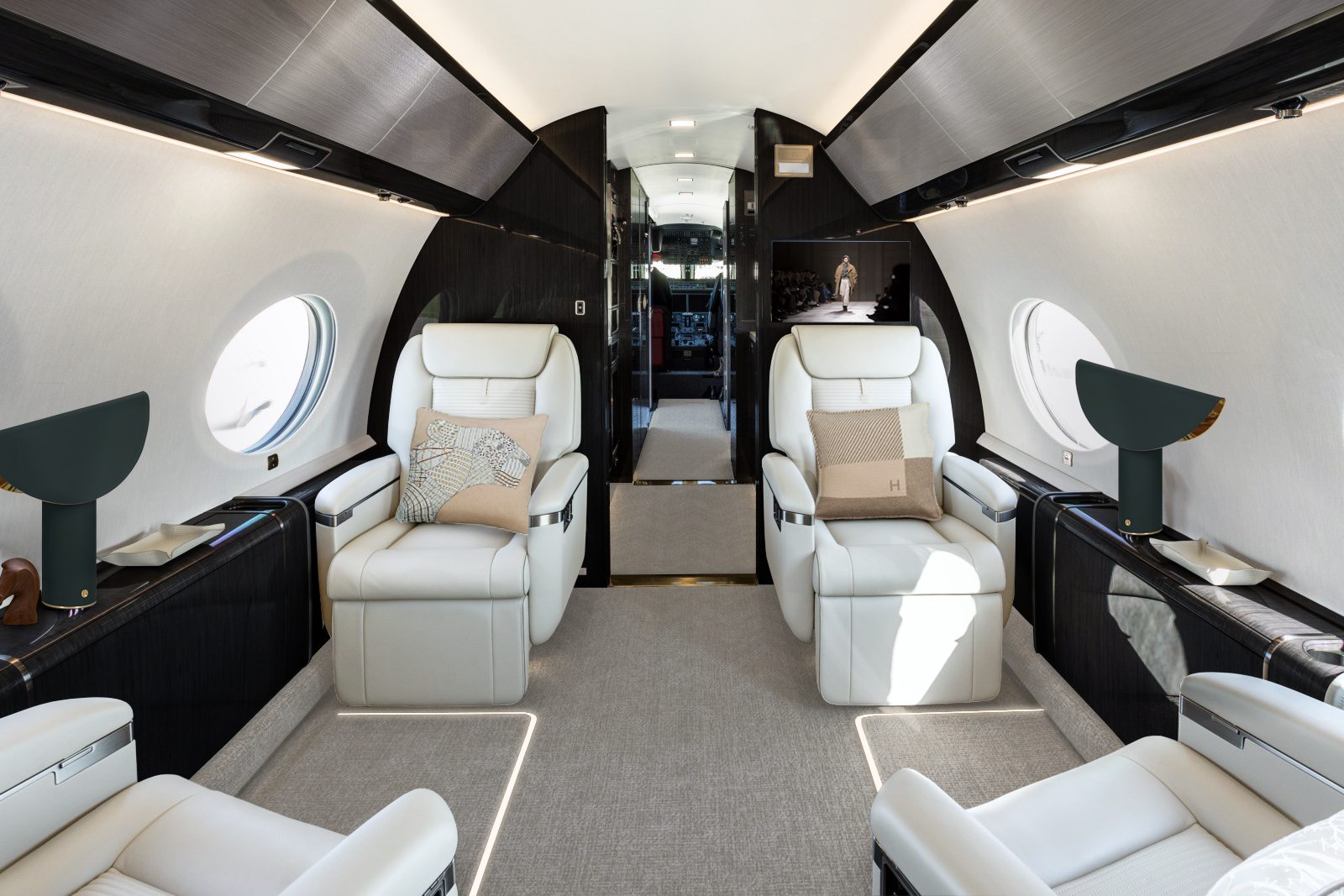 Gulfstream G650ER Lounge Area with a clear design, comfortable lighting and black wood panels.