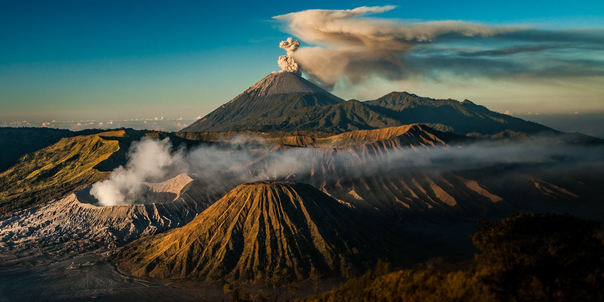 Primeval Tengger Caldera with active volcanoes Bromo in foreground and Semeru in background shortly after sunrise.