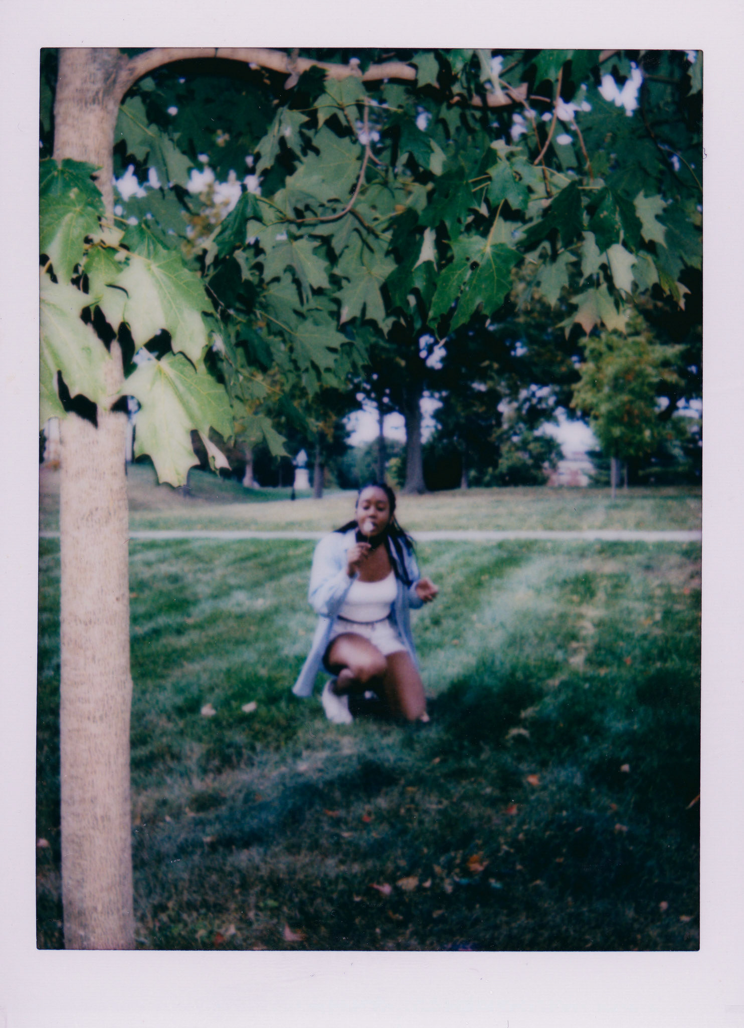 Maelle blows a dandelion