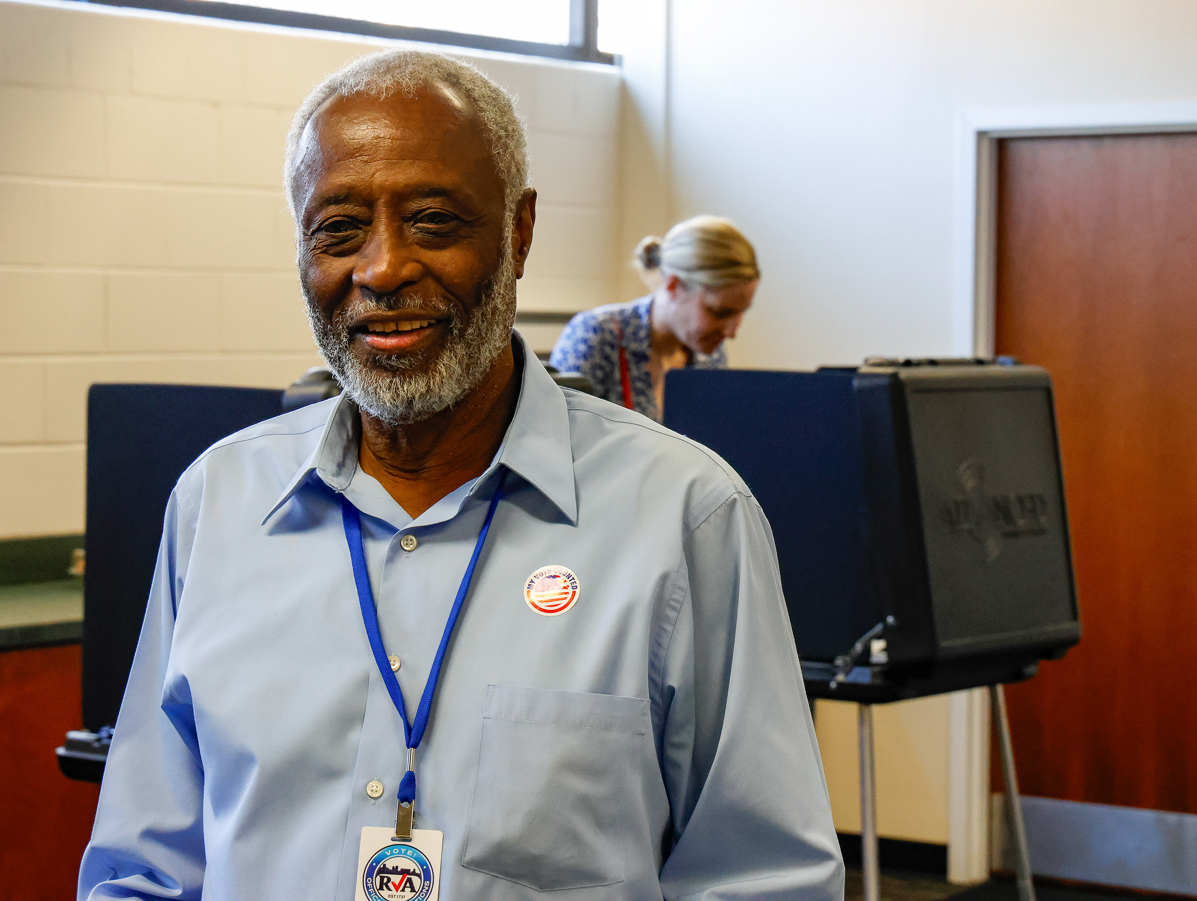 An election officer brings the joy to voters and other co-workers throughout the day at City Hall in Richmond, VA.