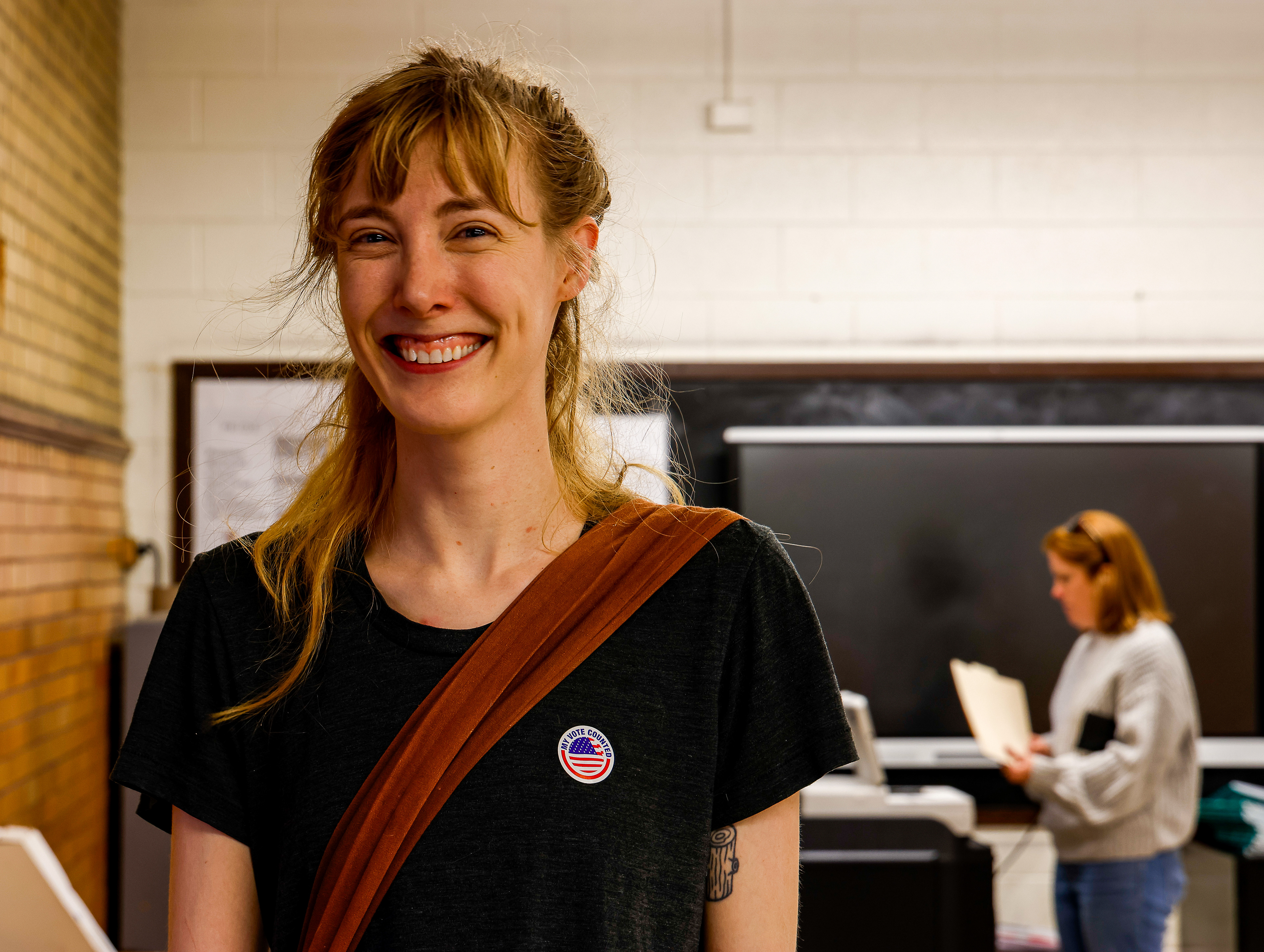 A voter is all smiles after handing in her ballot at Albert Hill Middle School in Richmond, VA.