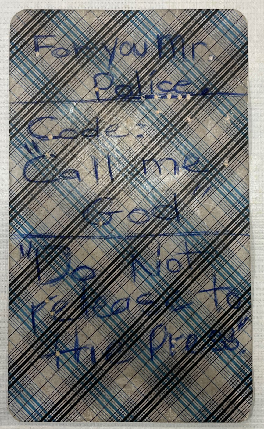 Back of card with a message to law enforcement written on it.