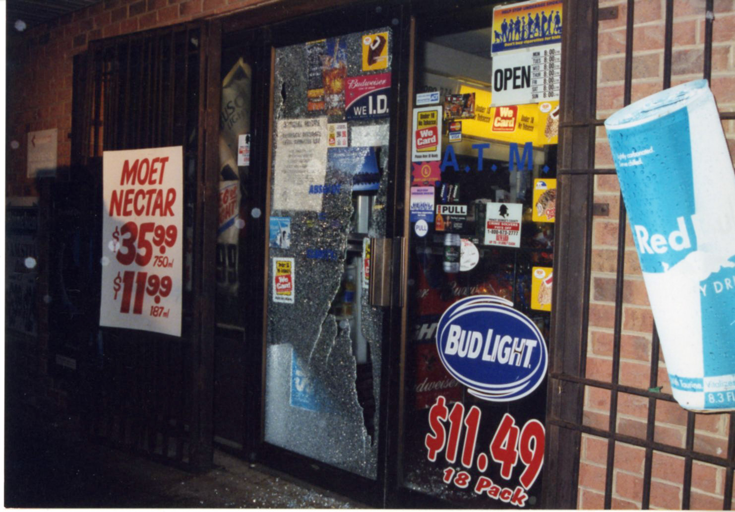 Shattered glass from where the bullet entered the storefront.