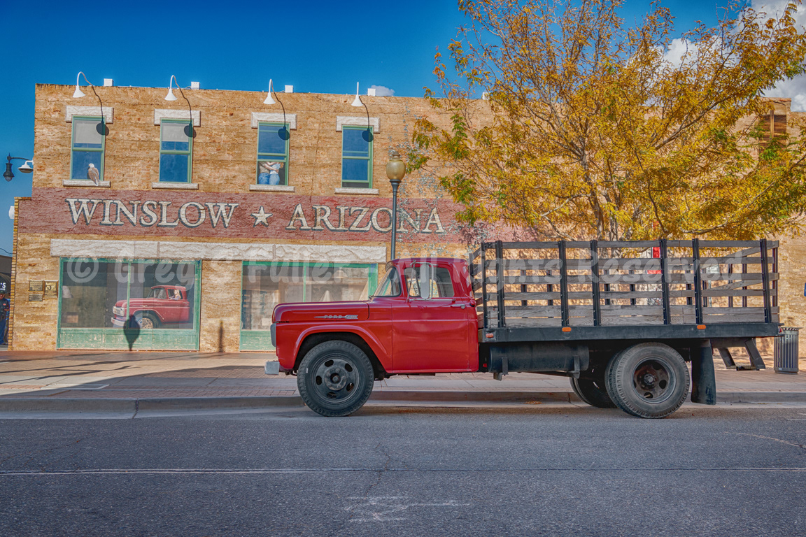 Standing on the Corner of Winslow, Arizona with a flatbed Ford with golden fall colors