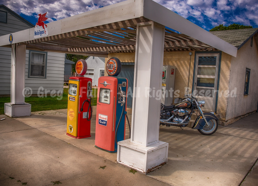 Vintage gas pumps (Gulf, Shell, Mobilgas) with Replica Indian motorcycle - Scott City, Kansas