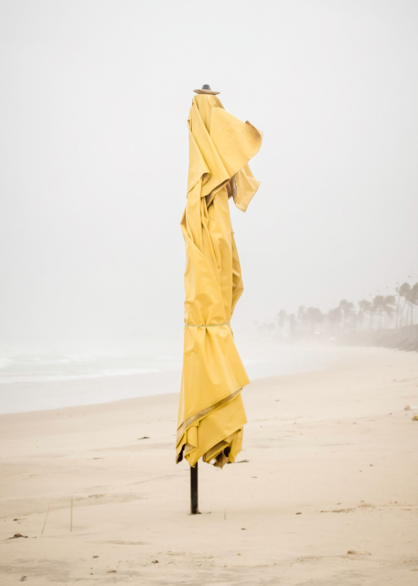 Pelourinho - Colorful neighborhood made specially for tourists. The term originally named a stone post feared by slaves, used for public humiliation and whipping.Part of Liquid Beach series:As hut owners begun to be expelled from the sands of Salvador’s beaches, their resistance took shape through umbrellas and plastic tables, mythical symbols of the local culture. Their colorful shapes erected against the gloomy horizon set the stage for a visual dictionary of the country's social-economic history, each title referring to an issue yet to be resolved.Liquid - Drinkable amorphous substance. When ingested in despair causes drowning (or drunkenness). Humanity’s current state according to Bauman. Quality of the blood that flows.Beach - Brazilian history’s primordial stage. Where work, leisure and belief mingle. Where blood is boiled, poured and mixed. From where one can see the horizon and feel “saudade”. Where umbrellas arise as sculptures above the sand, watching over the people as saints and orixás.