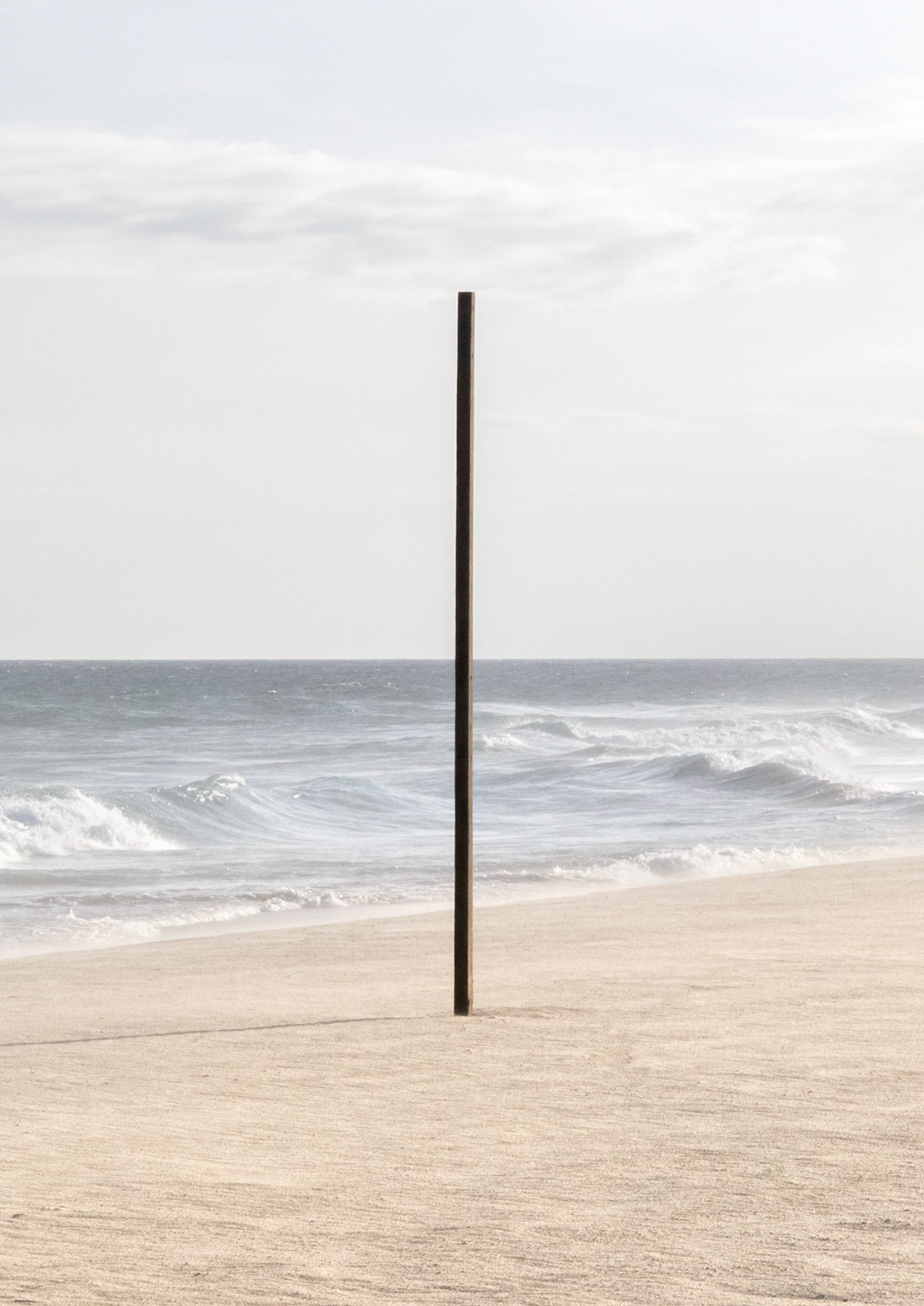 Cross - Painful shock of opposing forces. An instrument of torture used by Jesuit missionaries. A mark left on the land: city of Brasília.Part of Liquid Beach series:As hut owners begun to be expelled from the sands of Salvador’s beaches, their resistance took shape through umbrellas and plastic tables, mythical symbols of the local culture. Their colorful shapes erected against the gloomy horizon set the stage for a visual dictionary of the country's social-economic history, each title referring to an issue yet to be resolved.Liquid - Drinkable amorphous substance. When ingested in despair causes drowning (or drunkenness). Humanity’s current state according to Bauman. Quality of the blood that flows.Beach - Brazilian history’s primordial stage. Where work, leisure and belief mingle. Where blood is boiled, poured and mixed. From where one can see the horizon and feel “saudade”. Where umbrellas arise as sculptures above the sand, watching over the people as saints and orixás.