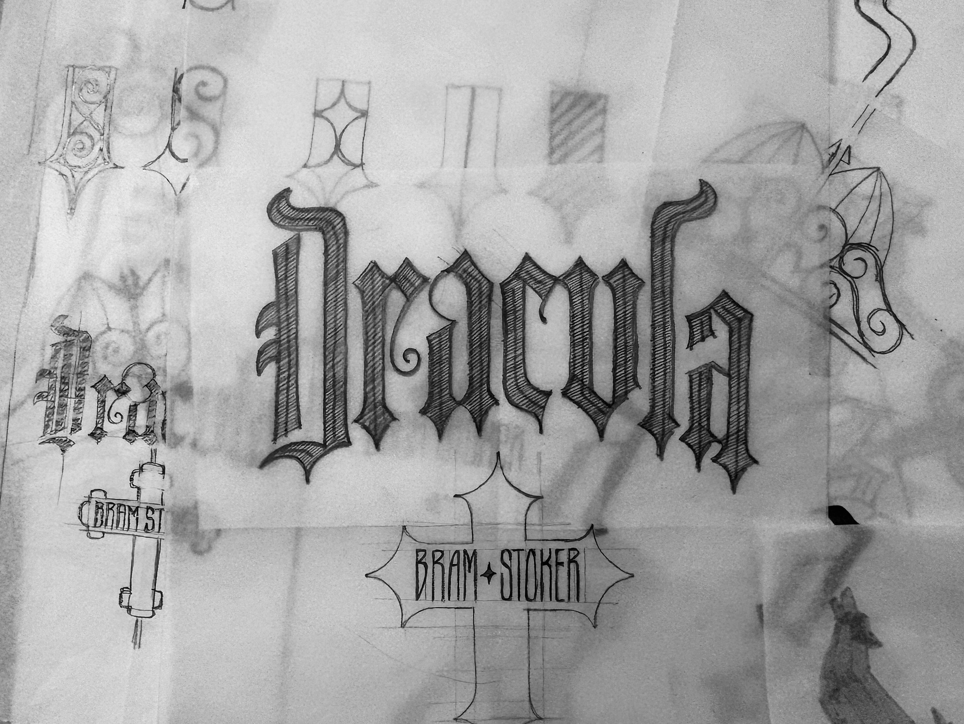 Pencil studies for custom Dracula title lettering, exploring condensed blackletter forms, decorative details, and a Bram Stoker author treatment.