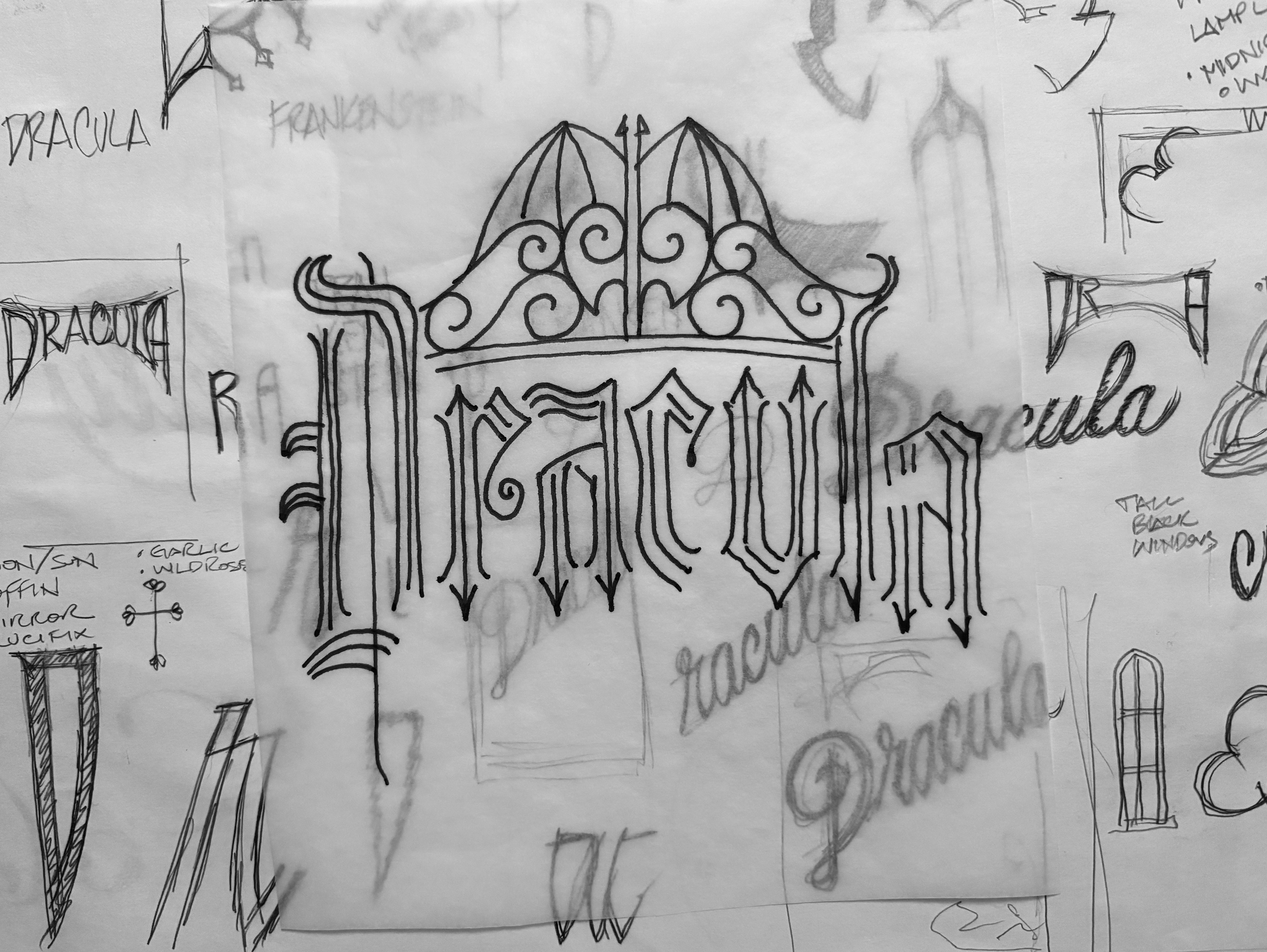 Dracula book cover concept sketches combining hand-drawn blackletter title lettering with an ornate wrought iron gate and bat-shaped crest.
