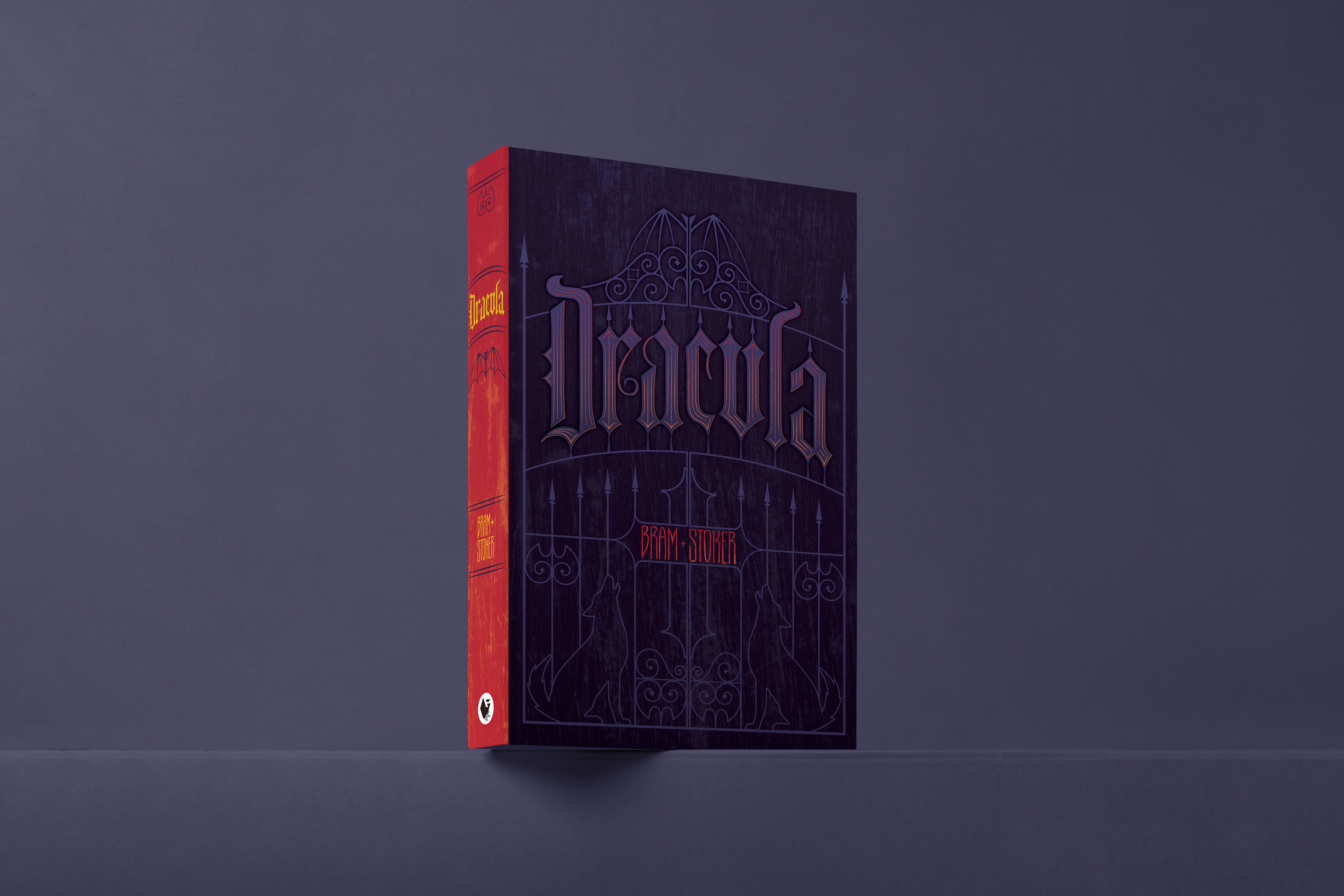 Dracula book cover design by Kevin Foley, featuring custom blackletter title lettering integrated into a wrought iron gate, with a dark purple cover and red spine.