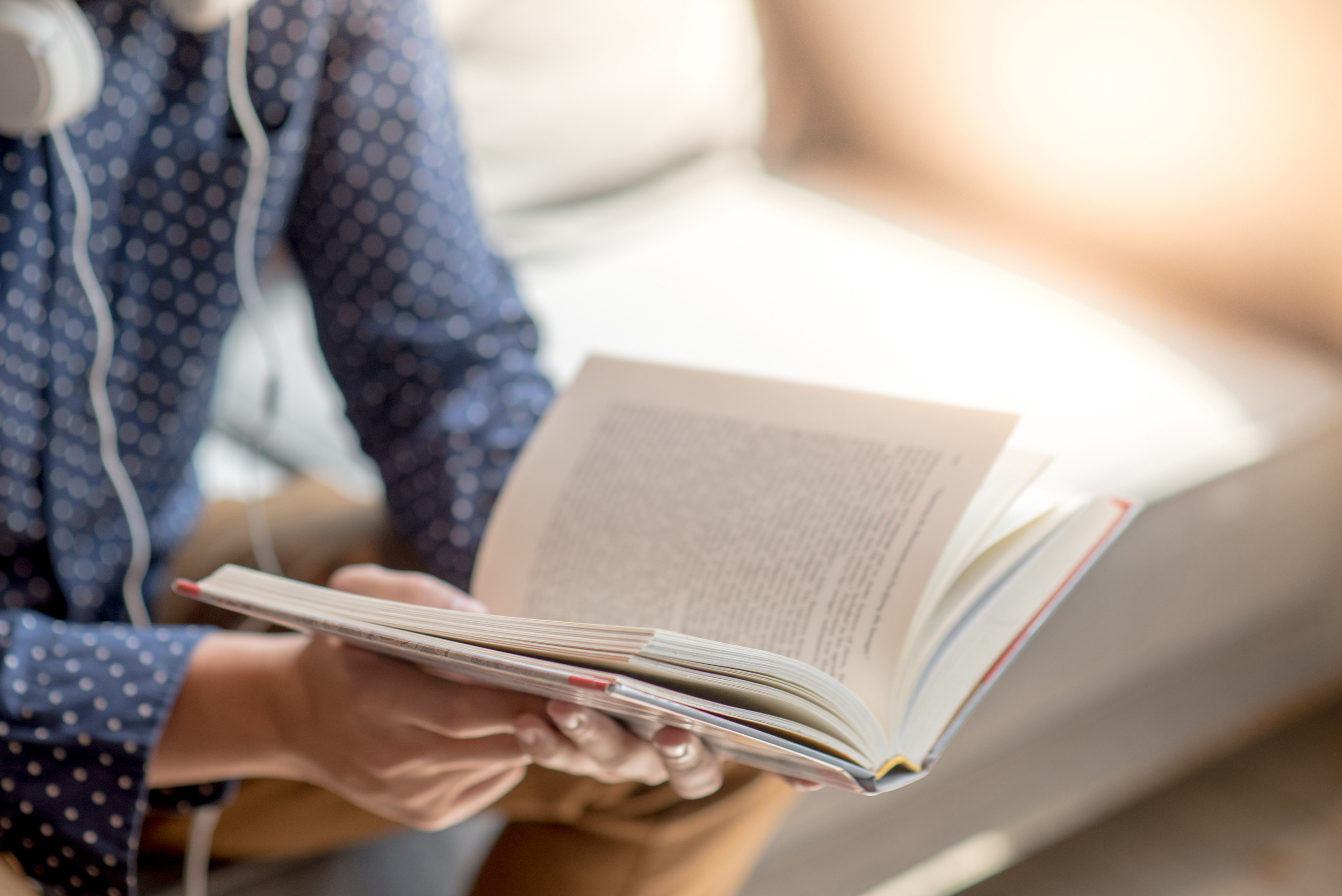 Image of person reading a book.