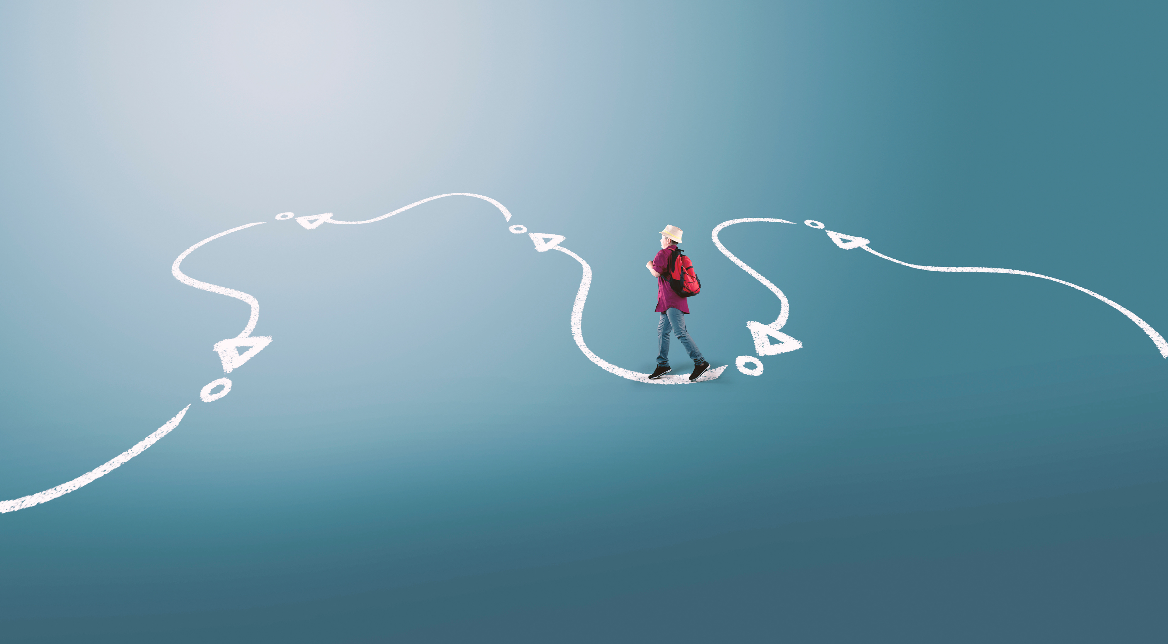 Image of young boy walking along a drawn white path.