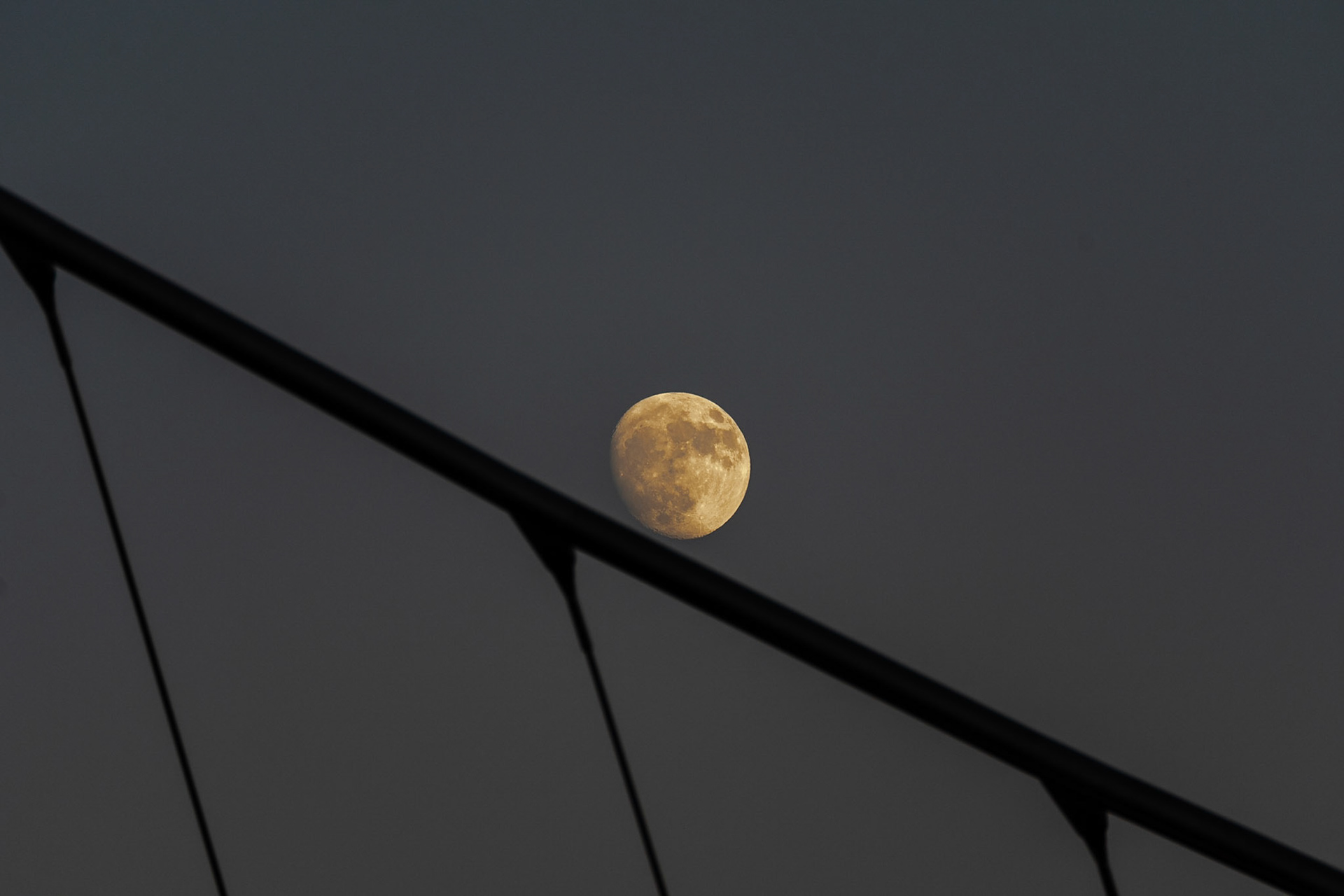 Moon crossing the pedestrian bridge on Harbor Drive.  #harbordrive #pedestrianbridge #moon #sandiego #gaslampdistrict #goldenhour