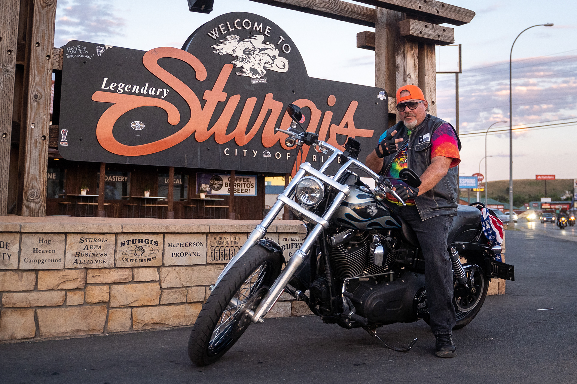 Tom Stokes of Dallas, Texas poses for a picture infant of the Sturgis welcome sign during the seventh day of the 81st Sturgis Motorcycle Rally in Sturgis, South Dakota. 08.12.21.
