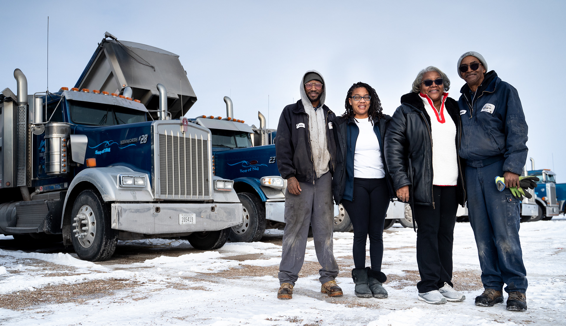 Stanford Madlock Jr. (from left to right), Champagne Perry, Amanda Madlock and Stanford Madlock Sr. pose for a photo in front of a row of their trucks outside their shop in Lincoln, Nebraska. 02.11.21.