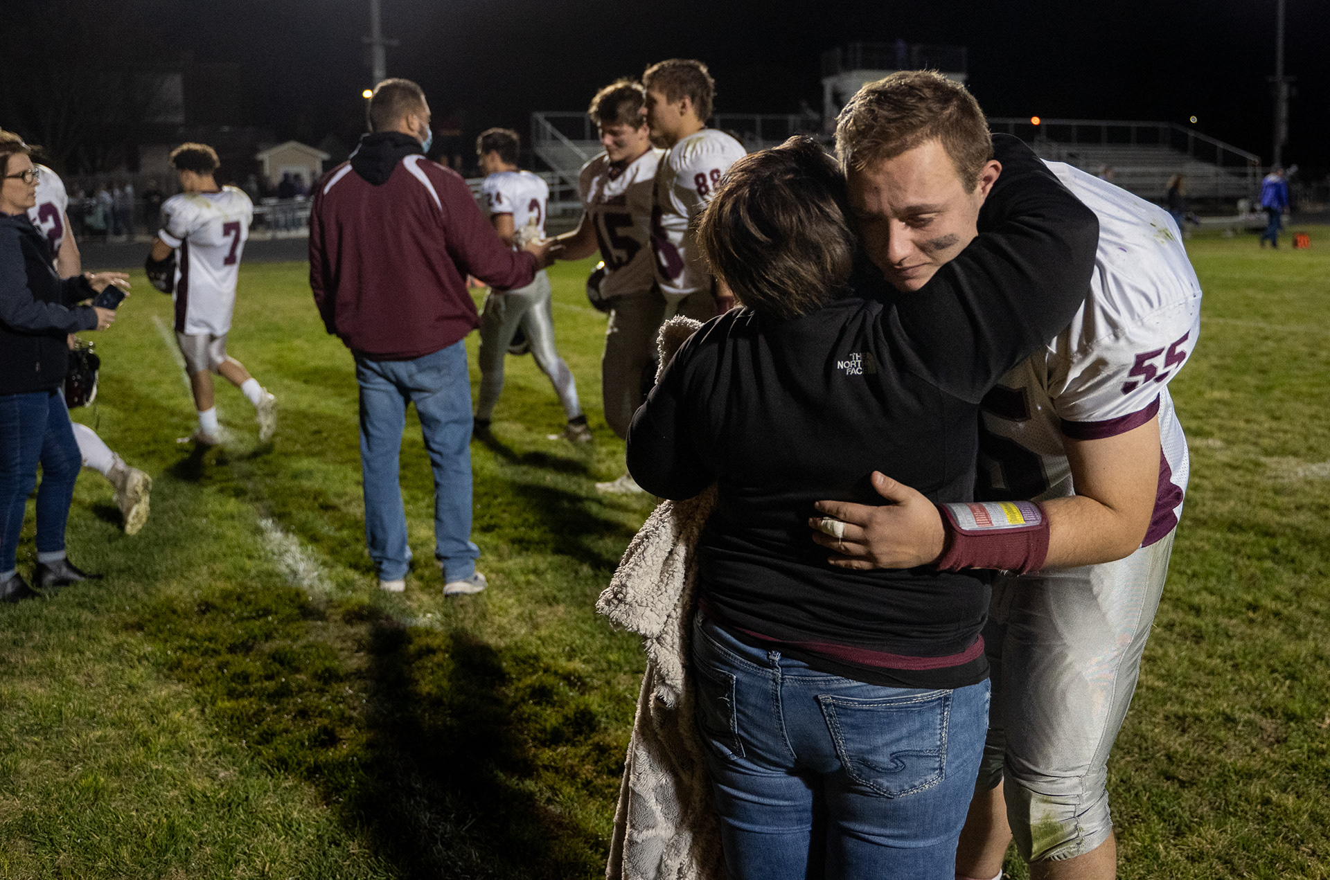 Neligh-Oakdale's Andrew Jacobsen (55) hugs his mother Traci following the Warriors' loss to Burwell in Burwell, Nebraska. 11.7.20.