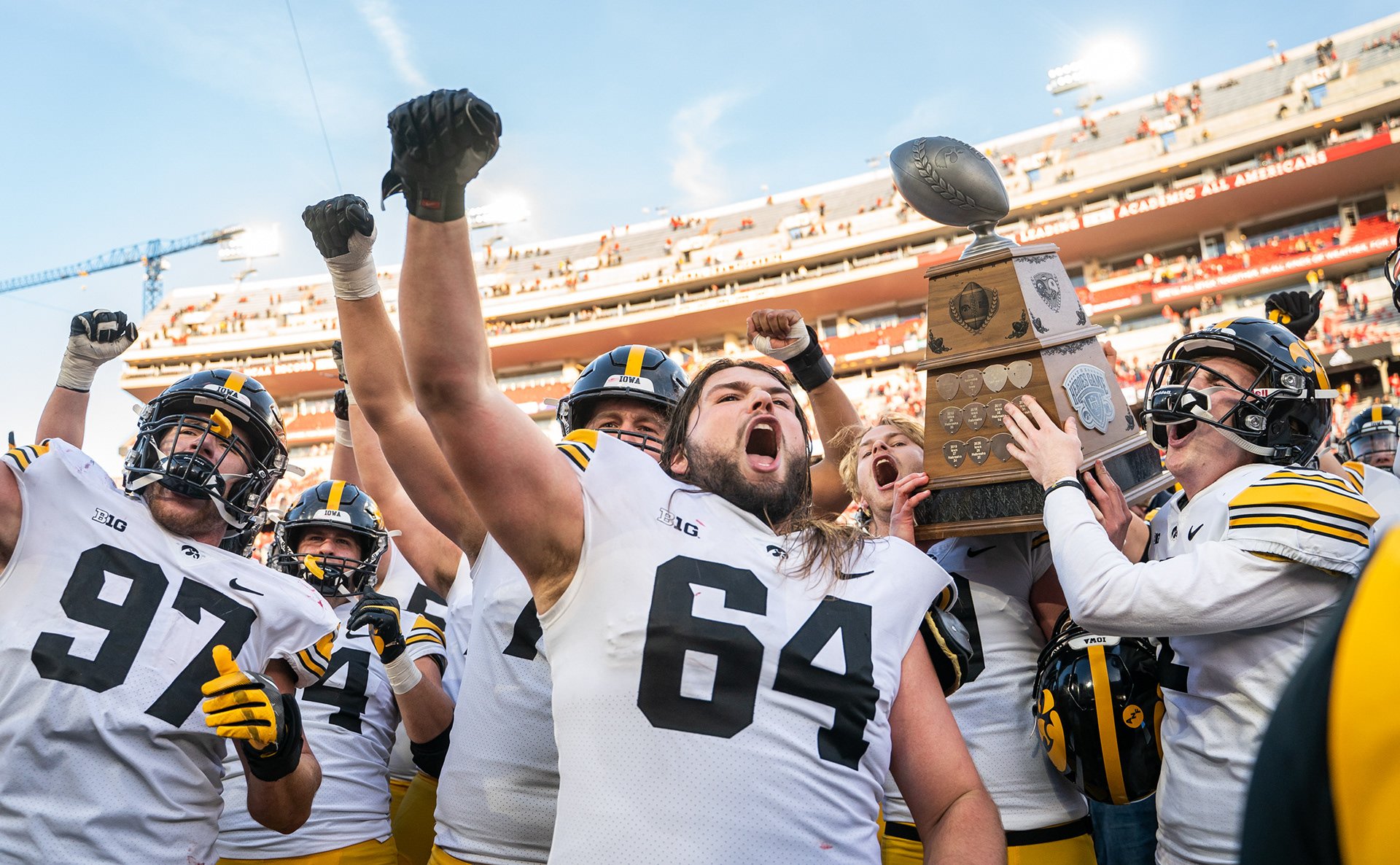 Iowa Hawkeyes players hoist the Heroes Trophy following their win over the Nebraska Cornhuskers at Memorial Stadium. November 26. 2022.