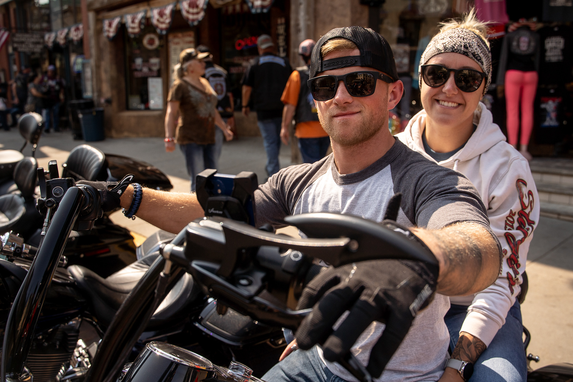 A couple poses for a portrait on their bike in downtown Deadwood, South Dakota during the fourth day of the 81st Sturgis Motorcycle Rally. 08.09.21.