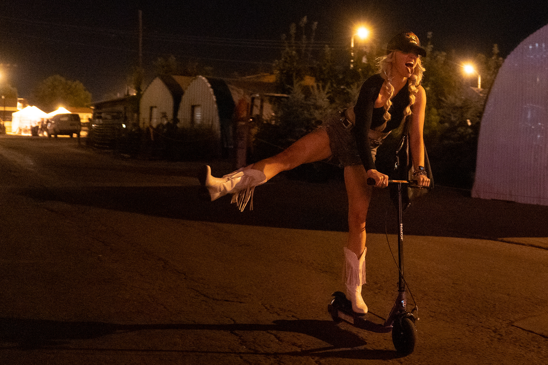 Britnee Kellogg rides a scooter down an alley during the seventh day of the 81st Sturgis Motorcycle Rally in Sturgis, South Dakota. 08.12.21.