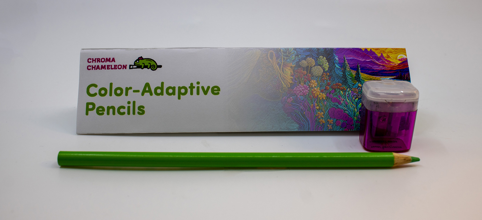 Image of the front of the Chroma Chameleon package design, with the logo, logotype, product name, and supporting graphic, with a magenta pencil sharpener and a Chroma Chameleon pencil changed to green