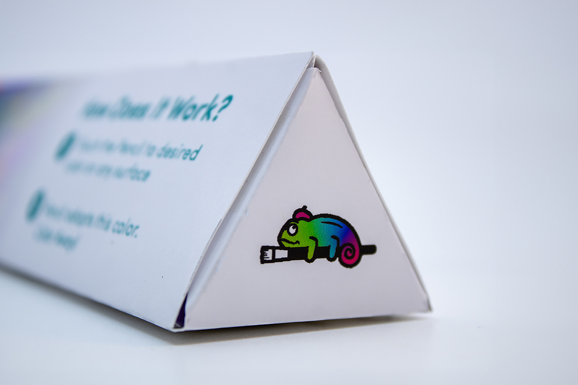 Image of the side of the Chroma Chameleon package design, focusing on a close-up of the green-blue-magenta gradient version of the brand logo